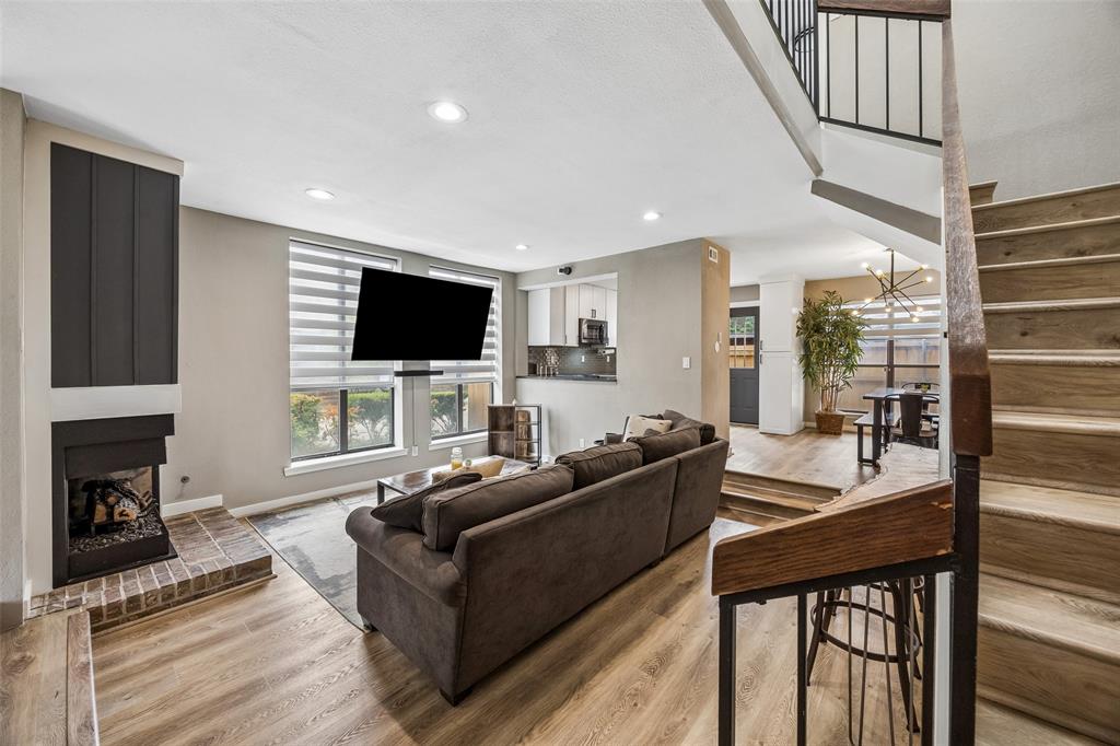 Beautifully renovated end-unit townhome in a prime Dallas location featuring 2 bedrooms, 2.5 bathrooms, and 1,448 square feet of thoughtfully updated living space. This move-in ready home offers modern finishes, abundant natural light, and a functional floor plan designed for comfortable everyday living.

Upon entry, you are welcomed by a spacious living room featuring soaring ceilings, luxury vinyl plank flooring throughout the lower level, a cozy fireplace, and a stylish wet bar. Just off the living room, a half bathroom, and a versatile secondary living area provides additional space that can be used as a home office, reading room, or additional living area. The layout flows seamlessly into the dining area and renovated kitchen, complete with quartzite countertops, ample cabinetry, a pantry, and updated finishes.

Upstairs, natural light fills the landing through a skylight. Both bedrooms feature private en suite bathrooms, while the primary suite includes access to a covered balcony. A dedicated utility closet with custom barn doors provides a convenient space for the washer and dryer, with additional storage throughout the home.

Just off the kitchen, the private gated patio offers a grassy area and direct access to two reserved covered carport spaces. Community amenities include a gated entrance, green space, and HOA-maintained exterior features.

Enjoy convenient access to the SOPAC Trail connecting to White Rock Lake, along with nearby shopping, dining, entertainment, NorthPark Center, Whole Foods, and Park Lane.