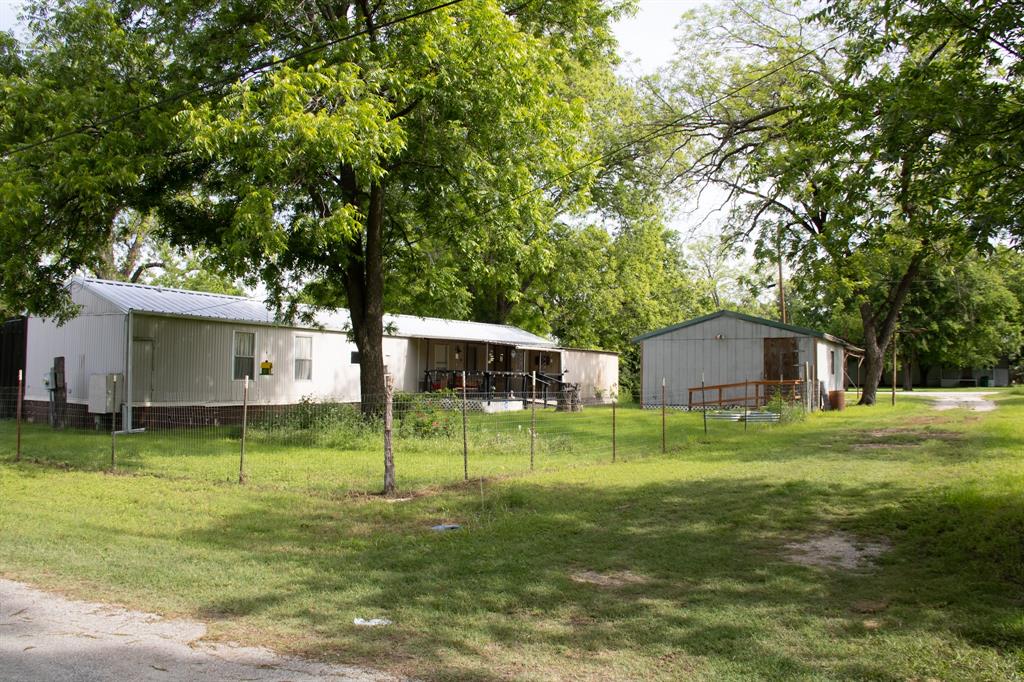 This well-kept 3 bedroom, 2 bath single-wide mobile home offers comfort, functionality, and a convenient location and budget friendly, full of potential, just minutes from Dublin. The home has been maintained with care and features central heat and air, new decorative lighting, new flooring in living and kitchen area and an ADT security system. Enjoy easy access with a wheelchair-friendly ramp leading to a spacious porch, perfect for relaxing. Fenced yard has mature pecan trees. The property offers plenty of versatility with a separate storage or area for craft room, a workshop with electricity, and a greenhouse space ready to be brought back to life. A long driveway stretches from one street to the next, providing ample parking and easy in-and-out access with large covered carport space. Whether you’re looking for a starter home, cozy retirement home, investment opportunity, or a place with room to create and tinker, this property offers great value. Mobile Home is Real property at original location. Lender available for your approval.
Refrigerator, washer, dryer and moveable island convey.