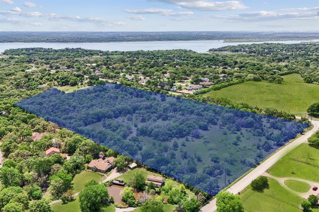 Endless Potential Awaits on 23 Pristine Acres in Flower Mound! This exceptional 23-acre property offers a rare opportunity for visionary developers or those seeking to create a one-of-a-kind private estate. Nestled in the highly sought-after LISD Flower Mound school zone—just minutes from Liberty Christian—this land is primed for a future of luxury and lifestyle. Whether you envision a thoughtfully planned residential community or a secluded, nature-filled retreat, the possibilities are endless. The land is graced with mature native trees, wildflowers, and a natural creek, creating a serene, park-like setting that's truly unmatched. Imagine crafting a subdivision where every homesite is surrounded by lush greenery, native wildlife, and scenic views—or keeping it all for yourself as a private haven designed to reflect your unique vision. Located just a short walk from a private beach and equestrian trail, outdoor adventures are right at your doorstep. Plus, with excellent access to Wichita Trail and Shiloh Road, commuting and connectivity are effortless. Whether you're a builder, investor, or someone looking for their own slice of paradise—this is your blank canvas. Come explore the possibilities and let your imagination take root.