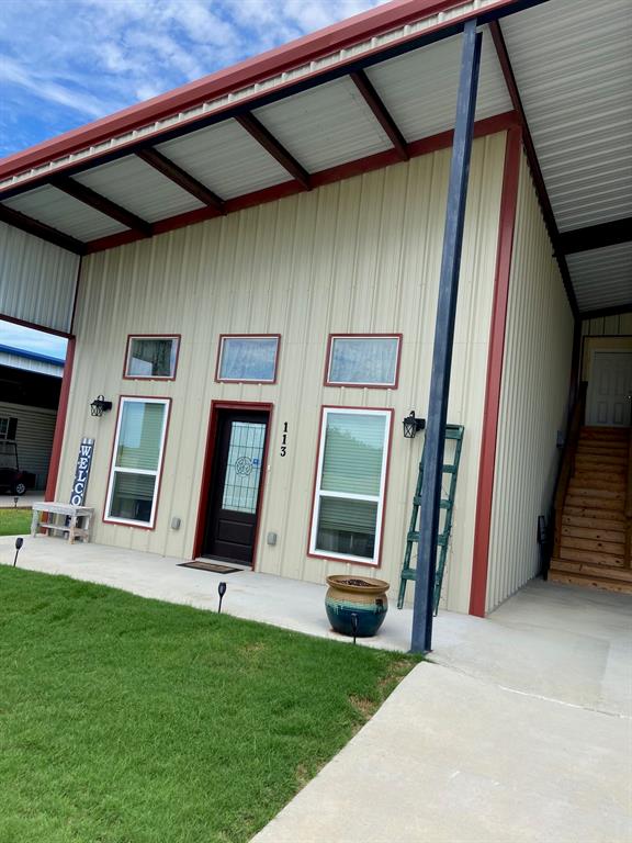 Like new; cute two bedroom home designed and built three years ago.  Community is a 55+ adult and no children allowed except for visitation.  There is a dog park, community pool, clubhouse, event center and many green and treed areas in the park.  The HOA fee includes water, sewer, trash, road and grounds maintenance and security gate.  Lots of curb appeal and a covered front porch greet your guests. Home is lovely inside with an open concept of living area, kitchen and dining.  The living area is very roomy with many windows that keep it bright.  The kitchen appliances were new with the build and the white quartz counters and neutral herring bone design of the back splash is a show place. The back side of the kitchen has an extended island counter for bar stools. The large pantry is behind the kitchen with lots of shelving.  The master bedroom is very spacious with room to have several pieces of furniture for a sitting area or office.  The bathroom is spacious with tub, shower combo, vanity with a built-in storage area.  The master closet is big with custom shelving. A second bedroom is also very spacious for guests and currently also has space for a piano and sewing area. Lots of curb appeal and a covered front porch welcome your guests. Plenty of covered parking for your autos, boat and RV.  The provided RV plug can host up to a 50 amp connection.  Have a golf cart?  There is a large enclosed storage area in front of the car port with a side garage to hold your golf cart all covered.  Plenty of lawn space surrounds the home for privacy and a covered back patio is spacious to entertain guests.  Current owner has a small fenced space in the back yard for a dog and a vegetable garden. The land under the home is not owned, so no property taxes.  More storage area is in the attic accessed up a built in stairway from the carport. This community holds full time and part time owners for retirement and a vacation hub to relax.  Conveniently located near Lake Whitney!