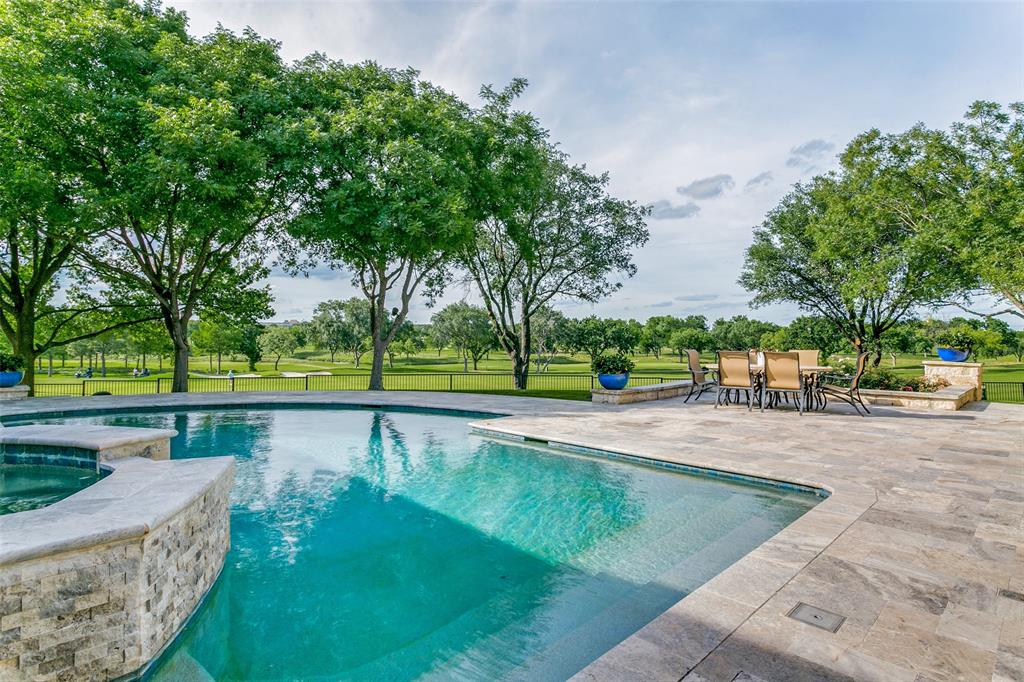 Welcome to this exceptionally updated home with sleek, modern finishes throughout and panoramic views of the Cottonwood Valley course at The Nelson Golf & Sports Club in Las Colinas! This home entertains beautifully inside and out. Drive up in the circular driveway with a porte-cochere for easy access to the home. Inside, you’ll be greeted by a floor to ceiling fireplace with a bookmatched granite surround as well as a stunning glass enclosed wine room with an acrylic wine rack system to store 700 bottles. The interior of the home has been meticulously updated since 2019 including limestone flooring, Wolf, Sub-Zero and Miele kitchen appliances, 30 hardwired window shades, a Control4 Home Automation System and more! The first level primary suite is a true getaway in itself, offering a private oasis with panoramic golf course views, two large custom walk-in closets, separate vanities, a soaking tub, and a glass enclosed walk-in shower. Venture outside and discover an entertainer’s dream! The recently renovated pool has plenty of space for seating and offers spectacular views of the golf course. The 450 SF cabana with kitchen was added in 2021 and features an IPE wood ceiling, a ceiling-mounted TV, an 11 ft gas fire pit, four Infratech heaters in the ceiling, and Hestan appliances including a grill, refrigerator, ice maker, warming drawer, and refreshment center. A second outdoor kitchen is located just outside the kitchen. The sound system in the backyard and cabana is amazing and perfect for entertaining your guests in style. Conveniently located in the heart of Dallas-Fort Worth with easy access to DFW and Love Field airports, dining, and entertainment. Take your golf cart to The Nelson Golf & Sports Club with 36 holes of golf, tennis and pickleball courts, fitness, indoor and outdoor swimming pools and more. Whether you're lounging by the pool, dining al fresco, or enjoying a round of golf right outside your door, this home offers an unparalleled resort lifestyle.