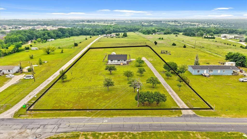 Charming Country Retreat on 2.4 Acres in Collin County,  Discover the simple joys of country living in this newly updated yet spacious 2-bedroom, 2-bath home nestled on 2.4 beautiful acres.  Updates to include: Roof, hot water heater, lower cabinets in kitchen, tile flooring and carpet.   Perfectly positioned just minutes from Highway 380, this property offers the ideal blend of peaceful rural charm with easy access to shopping, dining, and commuter routes.  The thoughtfully designed floor plan makes the most of its space, featuring a welcoming eat-in kitchen that opens into a comfortable living area—perfect for relaxing or entertaining. Though modest in size, the home lives large with smart use of space and an inviting layout.  Step outside and enjoy your morning coffee on the oversized front porch, or unwind in the evening on the private back deck with views of your open acreage. The property is fully fenced and gated, with separate areas ideal for both small and larger animals—making it a wonderful option for hobby farmers, pet lovers, or anyone seeking a bit of space and freedom.  Additional features include a handy shed for tools, lawn equipment, or extra storage, and the benefit of being located in the county—giving you more flexibility and fewer restrictions.  Whether you're looking to downsize, invest, or enjoy a quieter lifestyle with room to grow, this property offers a unique opportunity to embrace country living without giving up convenience.  

Let’s get started—your peaceful retreat awaits!