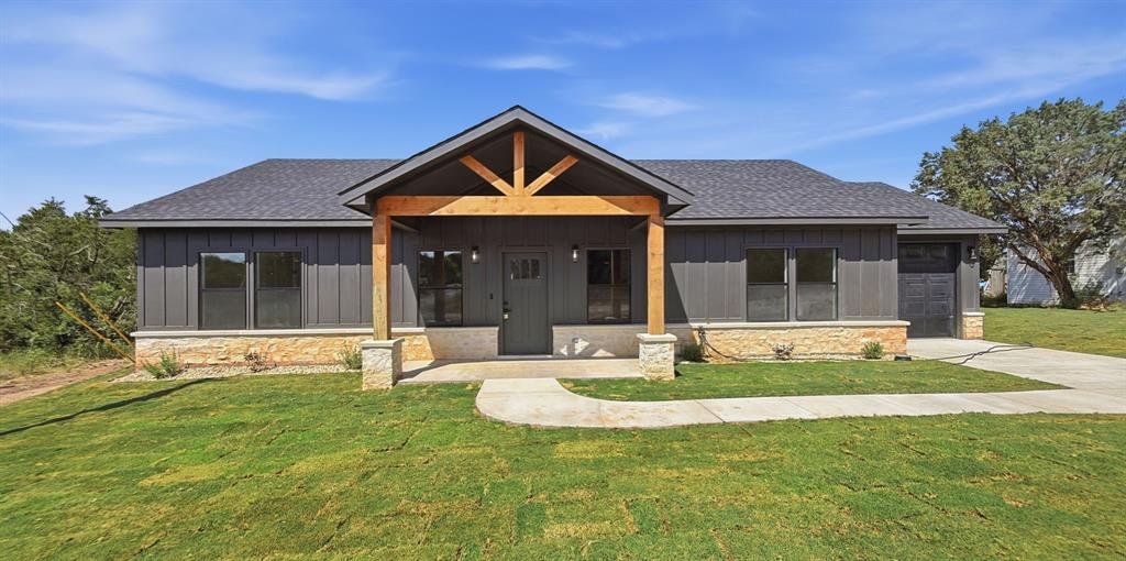 Brand new construction home proudly built with pride and craftsmanship by local Hood County builder Queen J Enterprises! Located in the gated community of Canyon Creek, this home shows attention to detail throughout and a very contemporary modern style. The basics: 3 bedroom, 2 bath, attached garage, and completed construction as of July 2026. The finer details: Luxury vinyl plank flooring throughout with no carpet! Elegant white quartz countertops in the kitchen, primary bathroom, and guest bathroom. Full electric stainless appliances in the kitchen that includes a cooktop range, dishwasher, and built in microwave. Large and very functional kitchen island overlooking the living room. Elegant and very functional electric fireplace in the living room with a very appealing black accent wood surround. High ceilings in the living room topped off with a very rustic cedar beam with attached high velocity ceiling fan. All windows throughout the home are double pane vinyl tilt sash windows. Both bathrooms have lighted mirrors with on demand air to prevent fogging after your relaxing hot shower. Primary bedroom is oversized with a large walk in closet and ample windows for beautiful natural light. Primary bathroom features double sinks and an extra large walk in shower. Bedrooms 2 and 3 are large with walk in closets and ceiling fans. Separate utility room with space for a full size washer and dryer, overhead cabinets, and a separate mud area with a built in bench, shoe storage, and backpack storage perfect for the kids school supplies. Exterior features great views of the community greenbelt from you covered front porch, full sod front yard, and landscaping. Back yard is also full sod. With an acceptable offer, builder will contribute an amount toward buyers closing costs. Full warranty included with purchase. Canyon Creek offers Lake Granbury access, 24 hour security, a gated and guarded entrance, several community pools, tennis courts, clubhouse, lake fishing, and dock!
