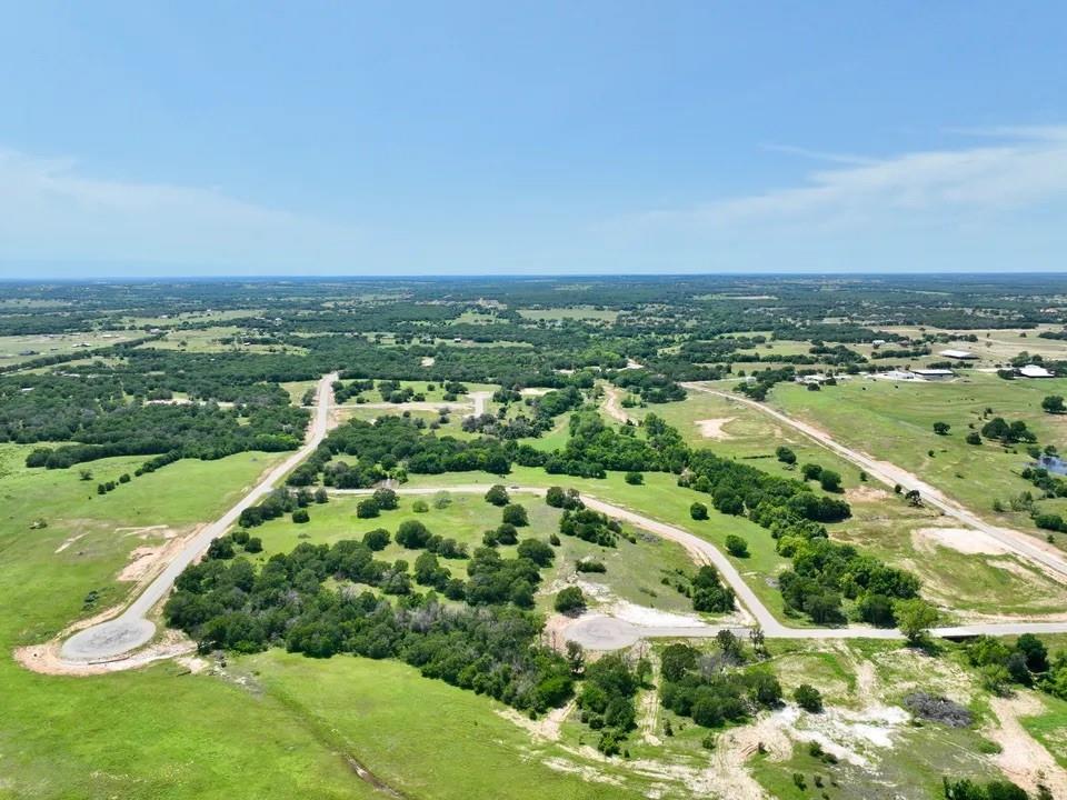 Discover the tranquil country lifestyle you've always dreamed of without leaving behind the career you've worked so hard to establish. Welcome to Sarra Ranch Estates, a private community offering 2–4 acre lots, just a short 35-minute commute from Fort Worth. Sarra Ranch gives you the rare chance to experience the best of both worlds—peaceful country living with stunning views of towering oak trees and rolling hills, while still being close to the conveniences of city life. The community is lightly deed restricted with no HOA, allowing you the freedom to choose your own builder and construction timeline. Workshops are also welcome. This is your opportunity to make your dream a reality. The property features paved roads, underground utilities, and high-speed fiber optic internet. Build your family’s future at Sarra Ranch Estates, located within the Poolville and Weatherford ISD. Barndominiums are not permitted. PHOTOS DISPLAYED ARE PHOTOS OF THE ENTIRE DEVELOPMENT NOT INDIVIDUAL LOTS