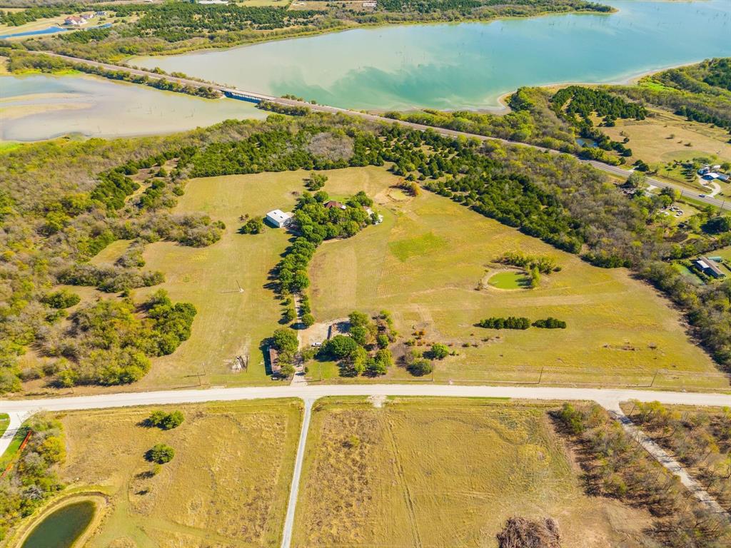 The subject property is a 30 acre site in the Princeton ETJ with a view of Lake Lavon. The property backs up to the Corps Property fronting the lake. The custom-built home on site exceeds 4,000 sf with high quality interior finish design, additional living areas, including 4 bedrooms, 4 full baths, 3 half baths, 2 fireplaces, swimming pool, barns and outdoor living space including a tremendous balcony. Additional parking, garage space and an additional suite for family or business. The property is very private offering secured living near the lake, or development potential with direct linkage to Princeton, McKinney, Lucas and Allen. Ag Exemption in place currently. The views of both lake and land are beautiful. No Floodplain.
The manufactured home on site is not included.