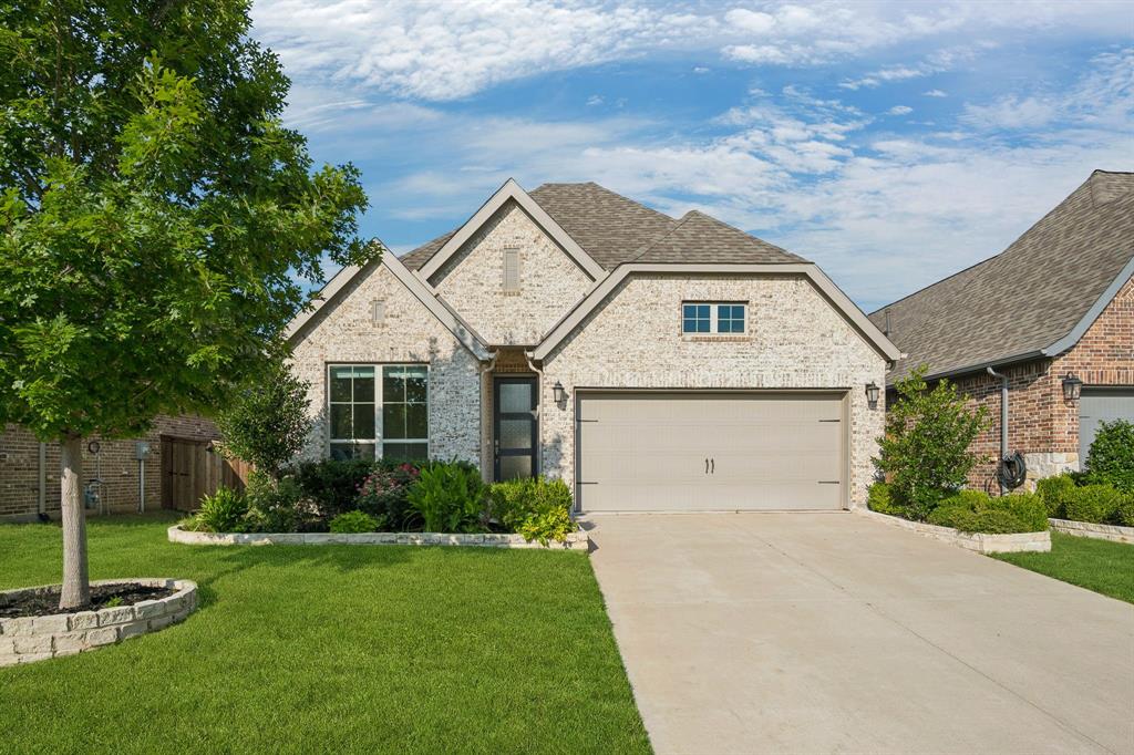 Welcome to this beautifully maintained one-story home in the highly sought-after Trinity Falls community of McKinney! Showcasing exceptional pride of ownership, this light brick home offers outstanding curb appeal with attractive landscaping, a covered front porch, and an inviting entry featuring a boxed ceiling and light wood-look tile flooring. Designed with an open-concept layout, this home offers 3 bedrooms, 2 bathrooms, a dedicated office, formal dining room, and spacious family room. The light-filled living area features a cozy fireplace, built-in bookcases, and a ceiling fan, creating the perfect space for everyday living and entertaining. The chef's kitchen is beautifully appointed with white cabinetry, a contrasting light gray island, quartz countertops, gas range, breakfast bar, coffee bar area, decorative lighting, and abundant workspace. Blinds throughout the home add both style and privacy. The private primary suite offers a relaxing retreat with a ceiling fan and luxurious ensuite bath featuring dual vanities, a garden tub, separate shower, and large walk-in closet. Two secondary bedrooms each include ceiling fans and are thoughtfully separated from the office, which overlooks the backyard—ideal for working from home. The spacious laundry room is both functional and stylish with upper cabinets, granite countertops, and a convenient drip-dry area. Step outside to enjoy the covered patio with ceiling fan and fenced backyard, providing the perfect setting for outdoor dining or relaxing evenings. Residents of Trinity Falls enjoy exceptional resort-style amenities including a clubhouse, community pools, scenic lake, parks, playgrounds, greenbelts, jogging and biking trails, dog park, and abundant open spaces. This move-in ready home combines modern finishes, functional design, and an unbeatable lifestyle in one of McKinney's premier master-planned communities.