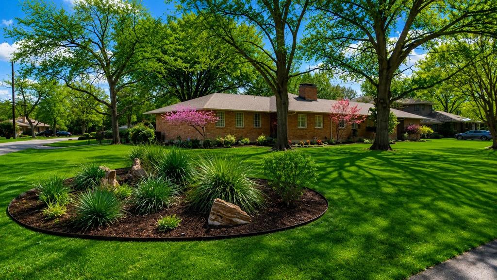 Not to be missed! A traditional Casa Linda Estates home on .524 acres beneath towering 70+ year old Oak trees and multiple Japanese maples throughout the property, offering expansive indoor-outdoor living, generous entertaining spaces, and the opportunity to bring your own vision to a substantial East Dallas property minutes from White Rock Lake. Inside, vaulted ceilings, hardwood floors, and walls of glass invite natural light throughout the main living spaces. A dramatic floor-to-ceiling fireplace anchors the great room while maintaining a comfortable flow to the dining and kitchen areas. The kitchen centers around a generous island with abundant prep and gathering space, creating a natural setting for everyday living and entertaining alike. A standout feature is the temperature-controlled wine cellar with capacity for approximately 1,500 bottles, an exceptional amenity for collectors and entertainers. The wine cellar space can easily be converted to a walk-in butler’s pantry with coffee station or wet bar. The spacious primary suite offers a fireplace, tranquil backyard views, a huge walk-in closet with custom shelving, and a large shower that is steam unit ready. 2 additional private bedrooms provide flexibility for guests, office space, study, or additional living needs depending on a buyer’s lifestyle. The grounds are designed for gathering and relaxation, featuring a massive covered outdoor pavilion overlooking terraced lawn space & multiple areas for dining, conversation, and evenings around the fire pit. In 2017, a significant renovation & expansion added approximately 1,000 square feet. Additional system improvements include updated HVAC ductwork, ultraviolet air purification, hot water recirculation, French drain systems, PVC in newer addition, newer water heater. A rare opportunity to enjoy substantial grounds, privacy, and flexible living spaces within one of East Dallas’ established neighborhoods. Enclosed side yard ideal for garden, gaming, hot tub.