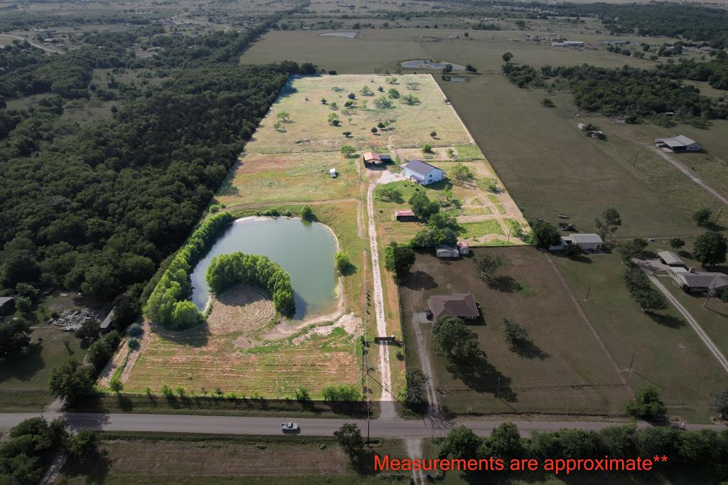 Set on 18.3 fenced and cross-fenced acres with a solar-powered gated entry, this AG-exempt property offers space, function, and privacy with cattle as the primary use and no HOA. Ideally located just minutes from Interstate 20 and U.S. Highway 175, commuting to Dallas is a breeze.

The property features a 2.5-acre pond reaching depths up to 25 feet, stocked for the past 6 years with catfish, Florida trophy black bass, native and hybrid bluegill, and redear varieties, perfect for fishing and outdoor enjoyment. A covered RV parking area with septic hookup and 50-amp electrical, detached carport, and lean-to parking provide excellent functionality. The attached workshop is wired with 30-amp service for a welder, and an approx. 15x20 partially enclosed barn adds even more versatility.

Inside, natural light pours through picture windows, highlighting polished concrete floors in the main living areas. The kitchen offers butcher block countertops, a center island with built-in bench seating, and peaceful pond and sunset views. The main-level primary suite opens to a spacious back patio, ideal for relaxing and enjoying the surroundings, while granite countertops elevate the bathrooms. An upstairs loft provides flexible space for work or play.

With approximately 1 acre designated as a homestead and an additional 17 acres AG-exempt, this one-of-a-kind property blends country living with modern comfort. Schedule your tour today and experience it for yourself.

Discounted rate options and no lender fee future refinancing may be available for qualified buyers of this home.