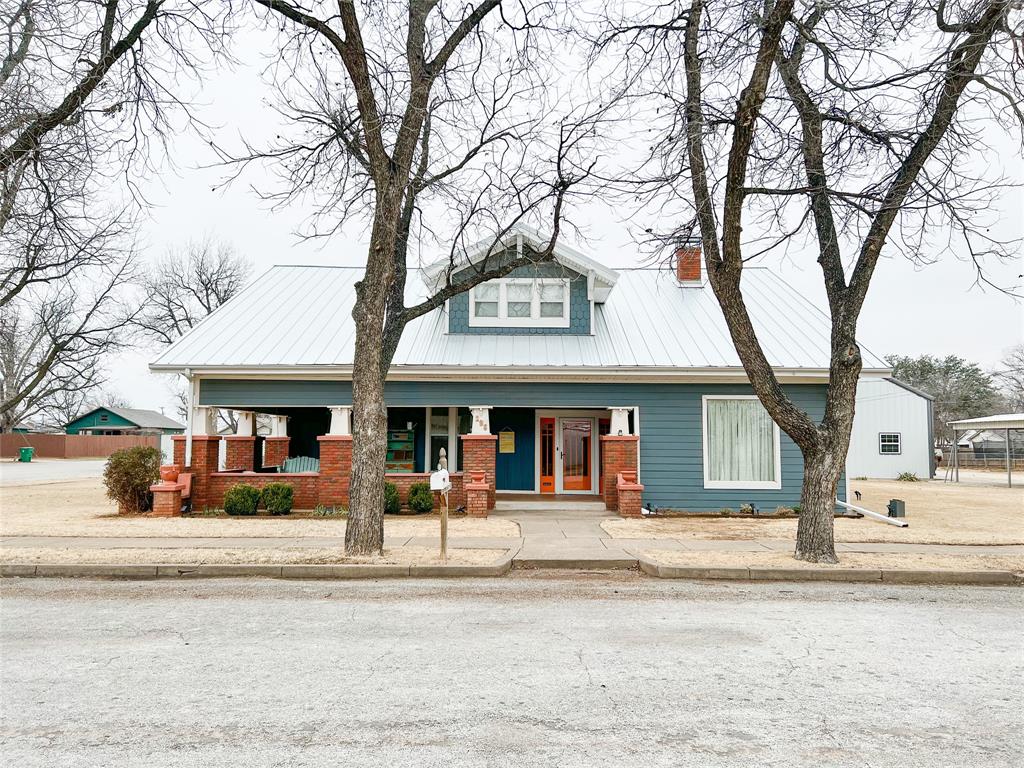 Modernized 1908 historic home sitting on a two lots with wrap around porch. This home has received all new foundation, wiring, plumbing, siding, spray foam insulation, class 4 standing seam metal roof and double paned windows. The original old growth pine floors have been refinished downstairs and brand new carpet installed upstairs. 4 oversized bedrooms and 2 bathrooms, with one featuring the original skirted tub. Kitchen received all new cabinetry and appliances, while keeping the vintage stove to preserve the character of the home. Backyard includes 6' privacy, metal fence with 24 ft above ground pool. 24x50 heated and cooled metal shop with 2 car garage also includes a 24x25 loft with wench lift for easy accessible lifting for storage. Additional one car carport located to the North.