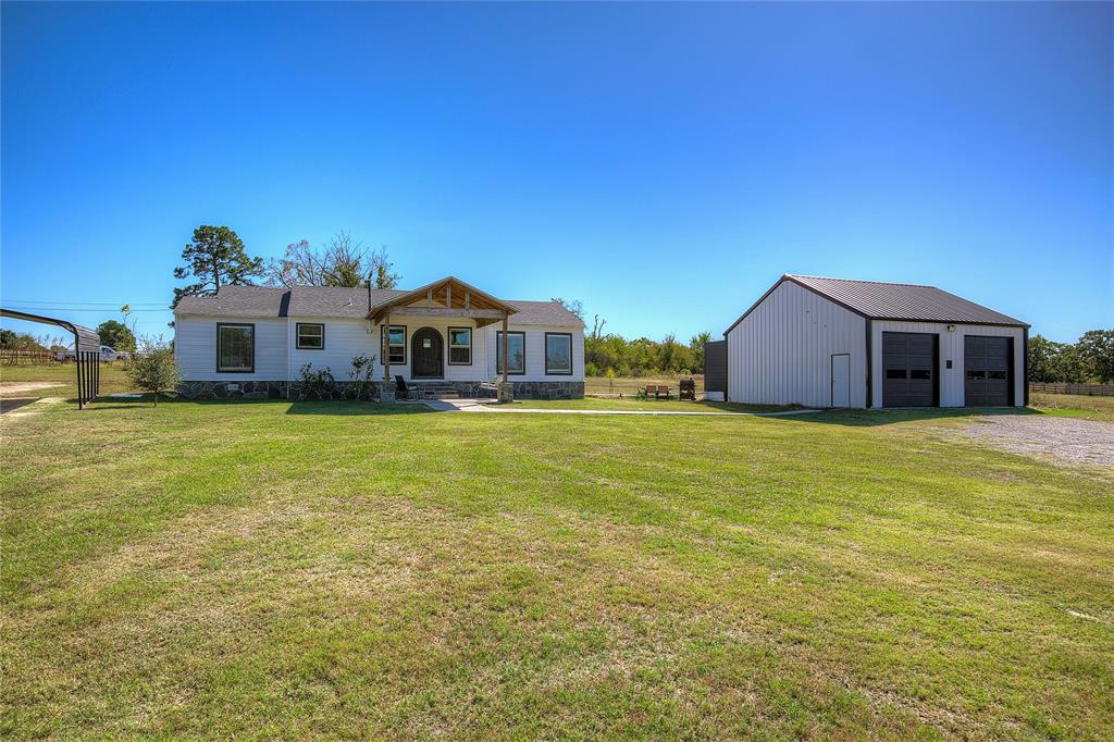 Exceptional Location for work, live and play! Highway frontage outside City limits with no restrictions. A total remodel 3 years ago, this cute farmhouse with Two Large Shops on 8.36 AC offers a unique opportunity. The perfect blend of residential style & commercial versatility, ideal for business owners, hobbyists, or anyone seeking space to live, work, and create. The remodeled home pairs modern style with practical design, while the expansive metal buildings provide endless possibilities for work, storage, or recreation.
Be welcomed to the 3 bed 2 bath home by a charming shaded concrete front porch with flagstone steps and a unique rounded front door that adds character and curb appeal. Step inside the inviting living room, which is open to the kitchen and dining area. The open-concept kitchen is a true centerpiece, featuring granite countertops, a breakfast bar, and two undermount sinks—one on each side for ultimate convenience. Plus SS range and vent hood, pantry nook and custom tile backsplash. 
The split-bedroom layout ensures privacy, with a spacious primary suite offering vintage hardwood floors, a walk-in closet, a ensuite bath with fully tiled step-in shower with glass doors, and a double-sink vanity. Two bedrooms on the other side of the house boast vintage hardwood floors and double windows. The hall bath also impresses with double sinks and a stylishly tiled walk-in shower.
Beyond the home, a 30x30 detached metal garage shop is a dream come true for car enthusiasts, RV or boat owners, or anyone needing serious workspace. It includes two high roll-up doors tall enough for large vehicles, lofted storage space, and even a full bathroom inside!
For business operations, an older 65x45 shop is currently configured as an auto body shop but could adapt to a variety of uses. It’s divided into office and storage or work areas, offering flexibility for multiple business types or large-scale projects. Road frontage along Hwy. 11 offers high traffic visibility.