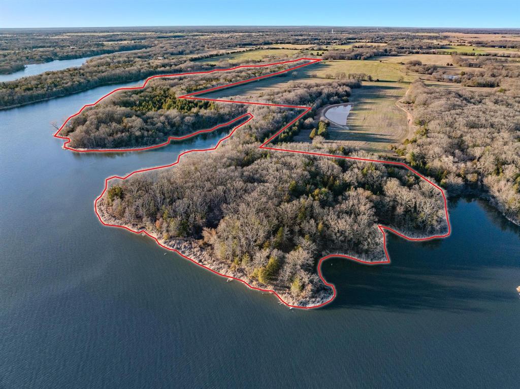 Discover a rare opportunity to own a remarkable 39+- acres of wooded, rugged, waterfront property featuring stunning panoramic views. Nestled on the shores of Bonham Lake, this  land boasts large mature oak trees, rolling terrain, and water access on three sides, making it an ideal setting for exploration and hiking. Whether you envision creating your own private oasis or developing a master-planned community, this property offers endless possibilities. Conveniently located just outside Bonham, you’ll enjoy the tranquility of nature while being less than 15 minutes away from shopping, schools, and restaurants. Don’t miss this chance to make your dreams a reality. ...................Utility providers are City of Bonham for Water and Fannin Electric for Electricity.  Buyers are responsible to verify all cost for development and services. Based on the flood map the majority of the land is in a flood zone. Land will be conveyed pursuant to signing a 99 year lease with the City of Bonham. The City will require the execution of new leases upon the transfer of any portion of the leased property. The City of Bonham has the right to reject all offers. .........Bonham Lake was built in the late 70's, is approximately 1,200 acres and offers, boating, fishing, swimming and camping.