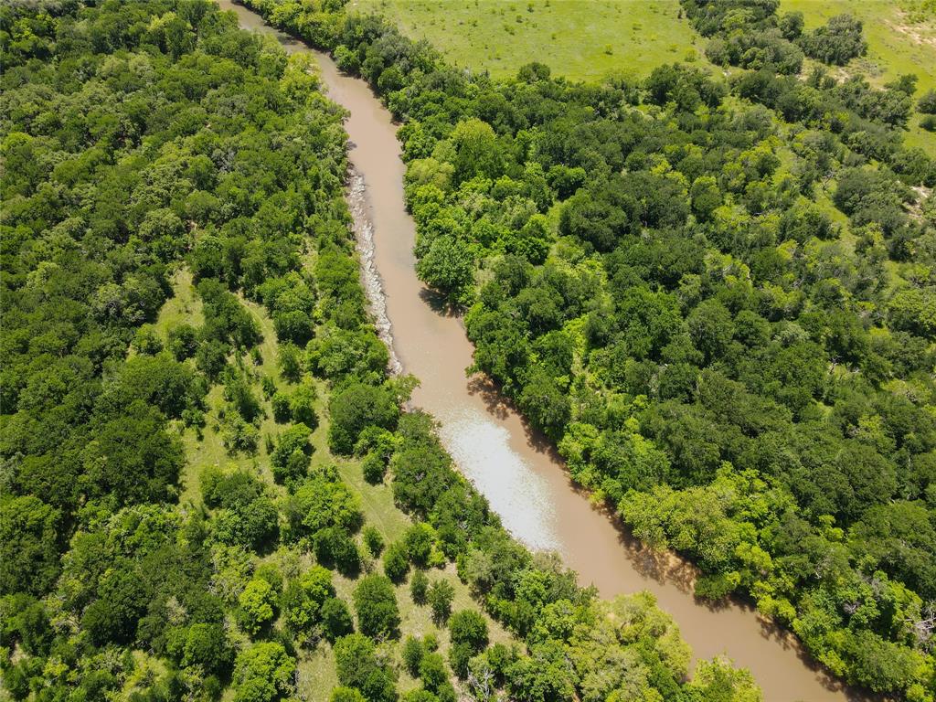 Riverfront acreage now available! Wildlife Exempt. Electricity on site. Conveniently located between Brownwood and Cross Plains, TX, this 56-acre tract offers incredible potential for a variety of uses. Whether you are looking to build your dream home, create a recreational retreat, or enjoy country living, this property is ready to go with a large concrete slab already in place and electricity connected.  Outdoor enthusiasts will appreciate the abundant wildlife, including deer, hogs, and turkey, making this an excellent hunting property. The western boundary of the land borders the Pecan Bayou River, providing scenic water frontage and convenient access just a short distance from Lake Brownwood—perfect for fishing, canoeing, and enjoying the outdoors.  The property currently carries a Wildlife Exemption, helping reduce property taxes. Horses and chickens are welcome, making it ideal for those seeking a peaceful rural lifestyle with room to roam.  You want country living? This is it!
