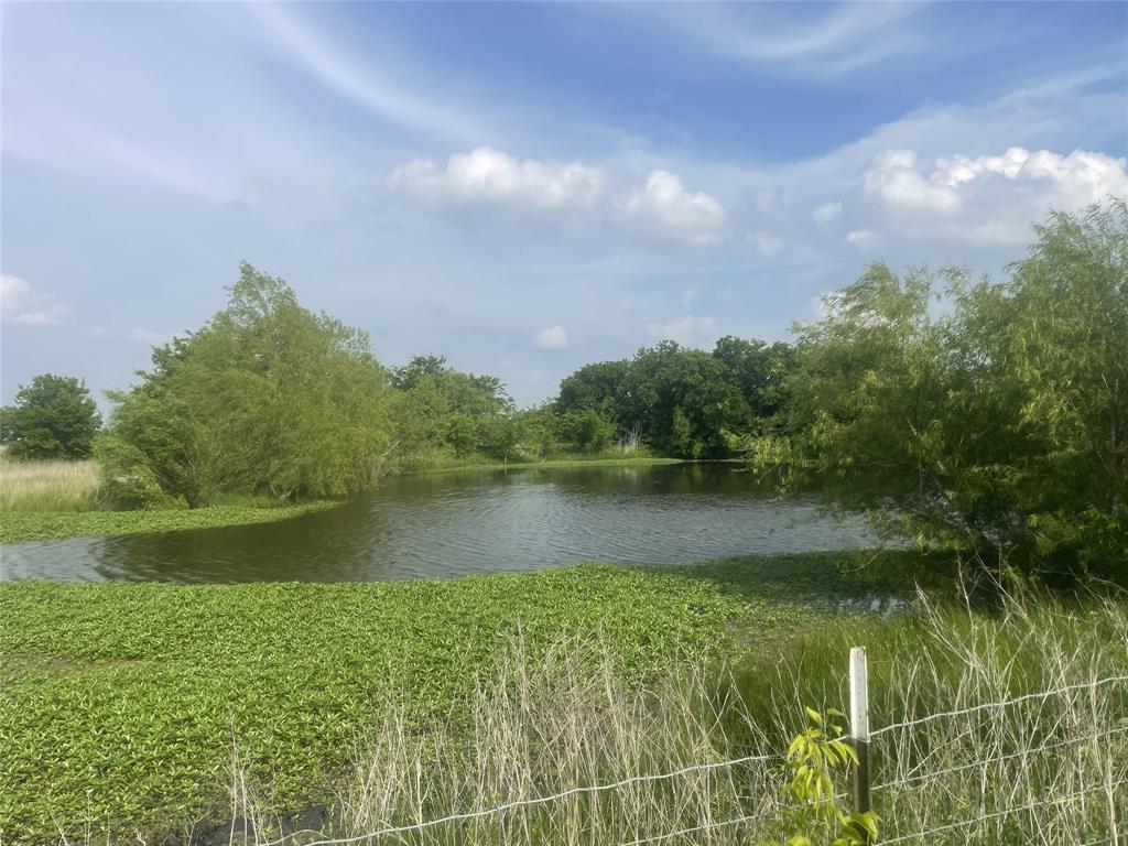 Looking for room to spread out & live the country life while close to conveniences? This one has it! There is a welcoming feel to the home & property, giving you space & functionality. You get 2 lots for 4 acres that is completely fenced with no climb fencing. The second lot already has it's own electric running to the pole. NO city restrictions or taxes & NO HOA. Enter the property at either of the 2 gated driveways & park under any of the 7 vehicle covered parking areas. Work on projects in the convenient workshop with electric that has covered parking to work. Step inside this impressive & comfortable home that has an open concept design. You get privacy with the split bedroom design & all on one level. Sit back & take in a movie in the large media room. There are custom features throughout with crown molding, custom ceiling fans, lighting & more. Be sure to ask to look at the extensive list of improvements made to the home & property. This comfortable & spacious modular home should not be mistaken for a mobile home as it is Not & is treated as site built home which you will see & feel once inside. Have you been wanting room & a place for keeping horses or just space to breath? This one delivers on many levels. There is an insulated barn with a loafing area that has water & electric, 3 separate gated pastures & 2 ponds with the largest not having dried that has fish, turtles & wild life that visit. If that is not enough than just sit back, relax to let your cares slip away looking out at your back yard with mature trees throughout. If you need easy access for commuting convenience, you can take the newly opened Dallas Parkway only a couple of miles down the road. This one truly has so much to offer that you have to see it to appreciate it. Grab the opportunity to own 4 acres & an wonderful home for less than others with features this one has in the rapidly growing Pilot Point area. Come see how special this one is to make it yours.