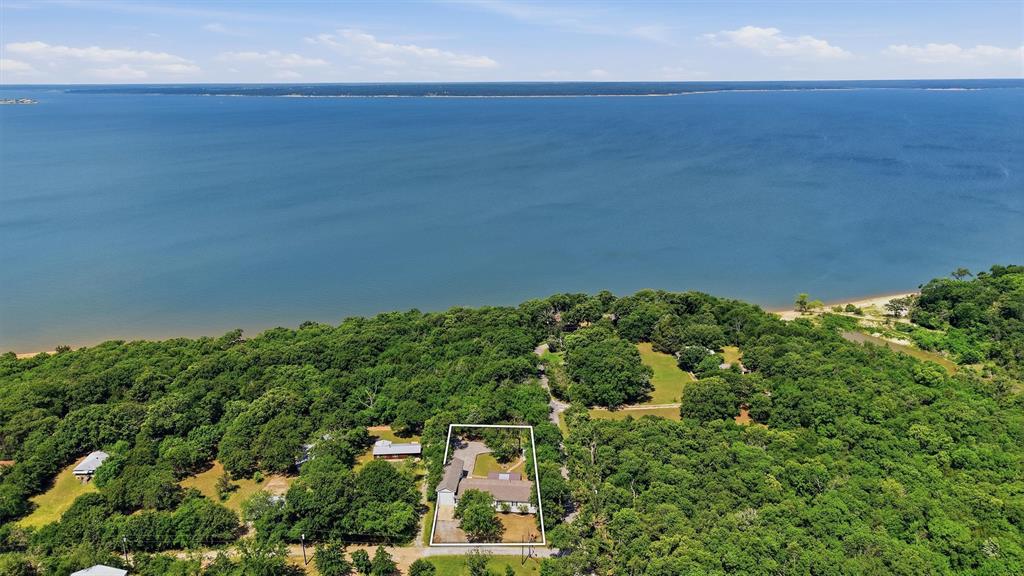 Welcome to 212 Sunset Road — a fully furnished 4-bedroom, 2-bath home offering the ideal combination of lake living, comfort, and investment opportunity near beautiful Lake Texoma. Situated adjacent to Corps of Engineers property, this home enjoys added privacy along with a walking path leading directly to the shoreline, making it easy to enjoy fishing, boating, and relaxing days at the lake. Built in Waco, Texas, this quality modular home is set on steel piers and I-beams and features spray foam insulation beneath the entire home for added efficiency and durability. The spacious layout is complemented by a large pull-through RV garage, providing excellent storage for an RV, boat, or all your lake toys. Outside, the large privately fenced backyard offers plenty of room for entertaining, gatherings, or simply enjoying peaceful evenings outdoors. Conveniently located close to several marinas, this property is perfectly positioned for those who want quick access to boating and recreation on the lake. Currently operating as an active short-term rental, this property presents an excellent opportunity as an income-producing investment, weekend lake retreat, or full-time residence. With furnishings included, it’s ready for immediate enjoyment from day one. Seller financing is an option with the right offer.