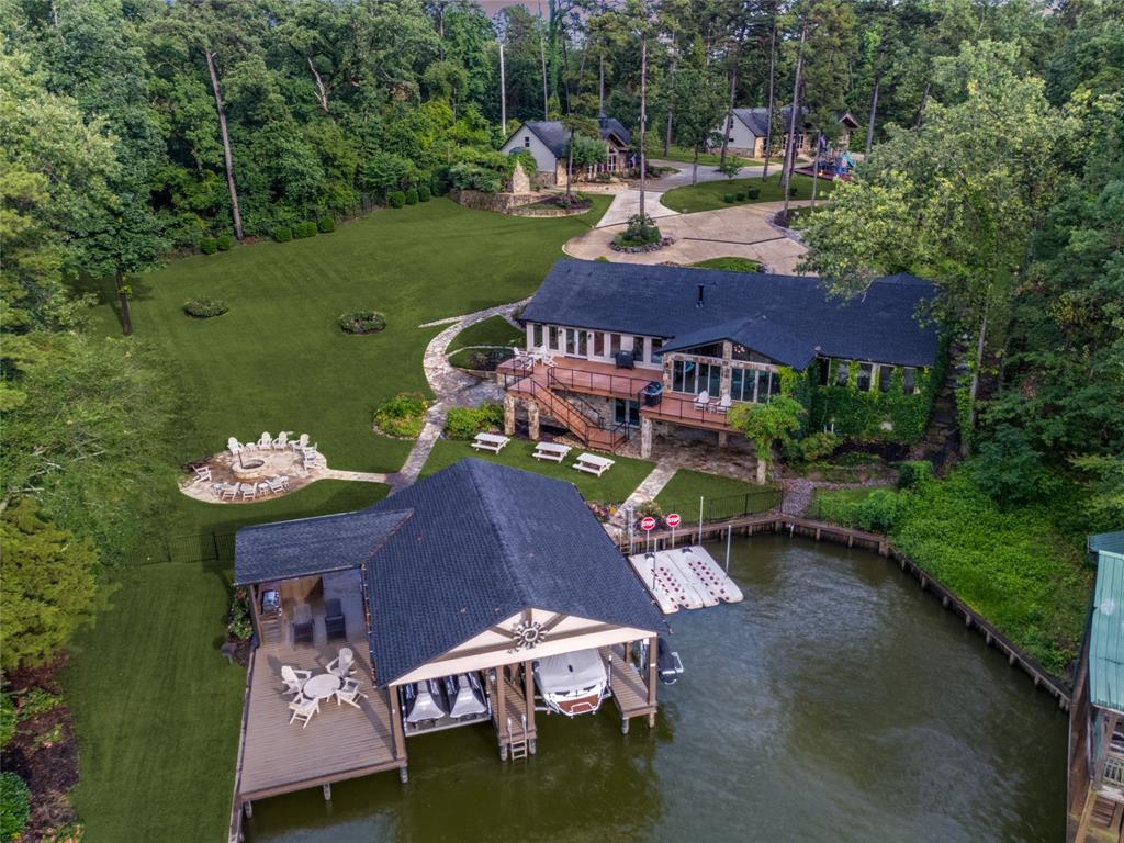 THE PREMIER LUXURY ESTATE ON LAKE CYPRESS SPRINGS. 
Situated on 3 lots spanning approximately 2 acres in the exclusive gated Pine Valley community, this extraordinary lakefront retreat features a NEWLY RENOVATED MAIN HOUSE, TWO PRIVATE GUEST HOUSES, and exceptional resort-style amenities rarely found in a single Lake Cypress Springs waterfront estate. This is a place that must be experienced. Few properties boast a lifestyle like this one. Beyond the private gates, entrants are welcomed into a world where luxury and comfort exist in perfect harmony, creating the ultimate setting for gathering, celebrating, and making lifelong memories. Sunlight pours through expansive custom picture windows, bringing the breathtaking beauty of the East Texas pines and manicured grounds into every room. The views become part of the home, creating a seamless connection between the indoors and the natural beauty beyond. Outside, towering mature trees provide peace and privacy, while gathering spaces, lush lawns, play areas, and covered outdoor living areas invite endless afternoons of relaxation, laughter, and connection. Whether enjoying a quiet morning coffee, hosting family and friends, or watching the sun set across the property, every space has been thoughtfully designed to be enjoyed, shared, and remembered. Located in a protected cove, calm waters provide an ideal setting for swimming, paddleboarding, kayaking, boating, and lakeside entertaining. Designed for large gatherings, the property comfortably sleeps 30+ guests, making it ideal for reunions, retreats, and multi-generational living. Features include a whole-house generator, newly constructed flex space, outdoor kitchen, multiple dining areas, firepit, lakeside restroom and shower, boathouse and dining areas, multiple lifts for your boats and jet skis. There's just too much to list! See supplemental info attached. Come and see the BEST Lake Cypress Springs has to offer!