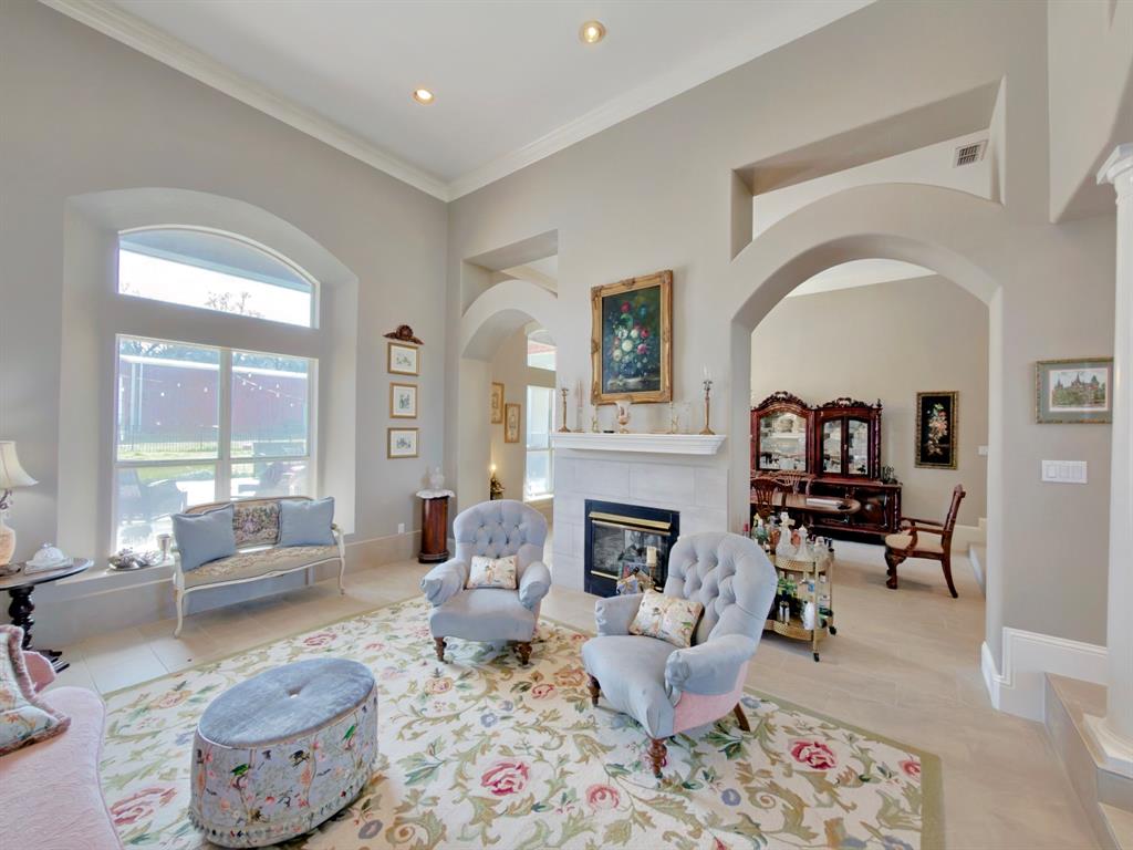 Exceptional custom home in Springtown offering space to entertain, relax, and pursue your hobbies - all with convenient access to Hwy 199 for an easy commute to Fort Worth and the greater DFW area. Inside, soaring 30-foot ceilings and abundant natural light create a grand first impression while multiple living areas provide flexibility for everyday living and entertaining. The thoughtfully designed kitchen is a true gathering space featuring double islands, generous prep space, and views into the main living area.

Unique architectural details set this home apart, including a striking built-in 350-gallon see-through aquarium and a beautiful see-through gas fireplace connecting the formal living and dining rooms. Additional interior spaces include a private office, media room, and relaxing sunroom, while plantation shutters add timeless style throughout.

Step outside to your private backyard retreat complete with a pool and sauna, perfect for relaxing or hosting guests. For those needing serious workspace or storage, the impressive 40’ x 40’ pull-through shop with electricity offers incredible versatility and is ideal for RV storage, projects, equipment, or a home-based business.

This property combines distinctive design, functional space, and exceptional amenities in a peaceful Springtown setting while remaining within easy reach of the conveniences of the DFW metroplex.

Professional photos coming soon!
