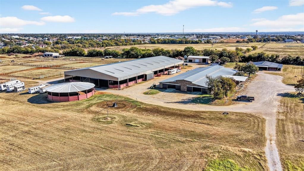 A rare opportunity to own 38.14 acres with a fully turnkey, premier equestrian facility positioned in the heart of Denton County's high-growth corridor. This expansive property is an exceptional home for serious horse owners and a strategic land investment with unparalleled commercial potential.  Located just one mile from Highway 377 and minutes from Highway 380, this ranch offers the perfect convergence of seclusion, world-class amenities, and immediate access to the entire DFW metroplex.  This property sets a new standard for equine care and professional training, capable of supporting a major show operation or functioning as a magnificent private estate.

Show Barn
42 Stalls of Luxury: An impressive, insulated show barn with 12'x12' stalls fully equipped with mounted fans, automatic waters, and corner feeders.  5 wash racks ensure rapid, high-volume care. The barn features modern LED lighting and two restrooms, one with a washer and dryer hookup.  A dedicated, rustic-chic Entertainment Lounge.  Two large 12'x24' tack rooms.  125’ x 250’ indoor arena with high-quality LED lighting.  A 12 or 24-stall Mare Motel or Overflow Barn.   A 60-foot covered round pen and a large 120’ x 260’ outdoor riding track are ready for any discipline.  The grounds features pipe-fenced turnout pastures with shelters. Two large 30’ x 60’ three-bay buildings provide essential hay and equipment storage.

Main Home (1,952 SF): The 3-bedroom, 2-bathroom.  Guest or Staff Housing: Two identical, independent 704 SF guest houses, 2-bedrooms, 1-Bath. 

This is a unique opportunity to secure an established, income-producing ranch while simultaneously holding a prime, strategic land asset in a high-demand North Texas growth market. Do not miss this chance to acquire a legacy property with massive future upside

Please refer to Supplement Sheet on Ranch for greater detail of Amenities