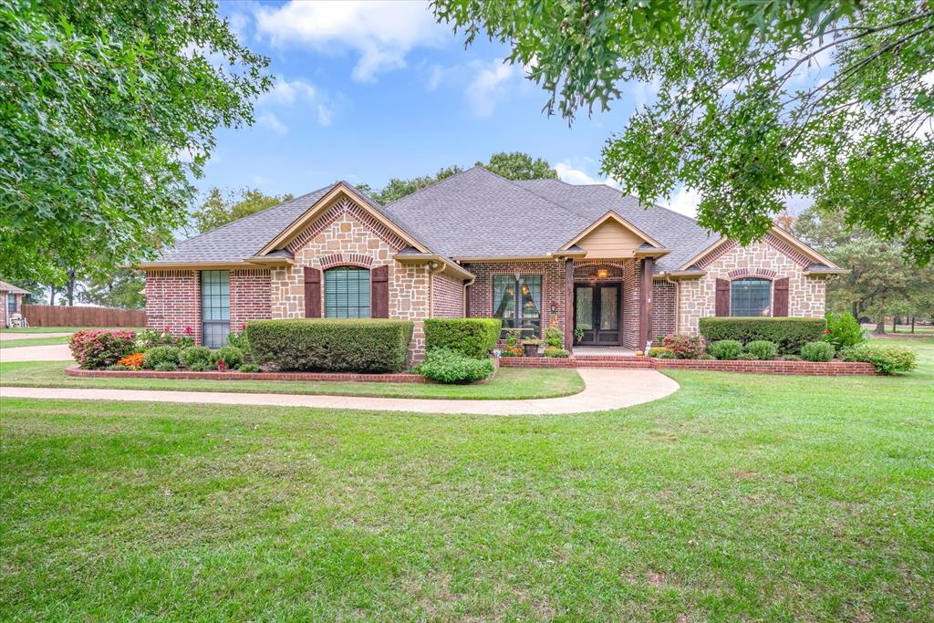Welcome to your family dream home nestled on nearly an acre Lindale, TX. This 4 bedroom, 2.5 bath home offers beautiful curb appeal, landscaping, mature trees with space for entertaining, gardening, enjoying your outdoor patio. Inside this 2,829 SF residence, you'll discover its perfectly suited for your family's needs. The heart of the home is open-concept, ideal for making memories with friends and family. The kitchen features modern appliances, abundant counter space, and a convenient island. Enjoy your formal dining room, with ample room for your cherished furniture, as well as a kitchenette space. The split floor plan is perfect for your family. The primary suite is complete with a private en-suite bath and generously sized closet. The 4th bedroom presents the option for a home office. Storage is available in the attached 2 car garage, and a 21' x 27' detached garage-shop. This is an excellent opportunity to live in this highly desirable neighborhood in Lindale schools.