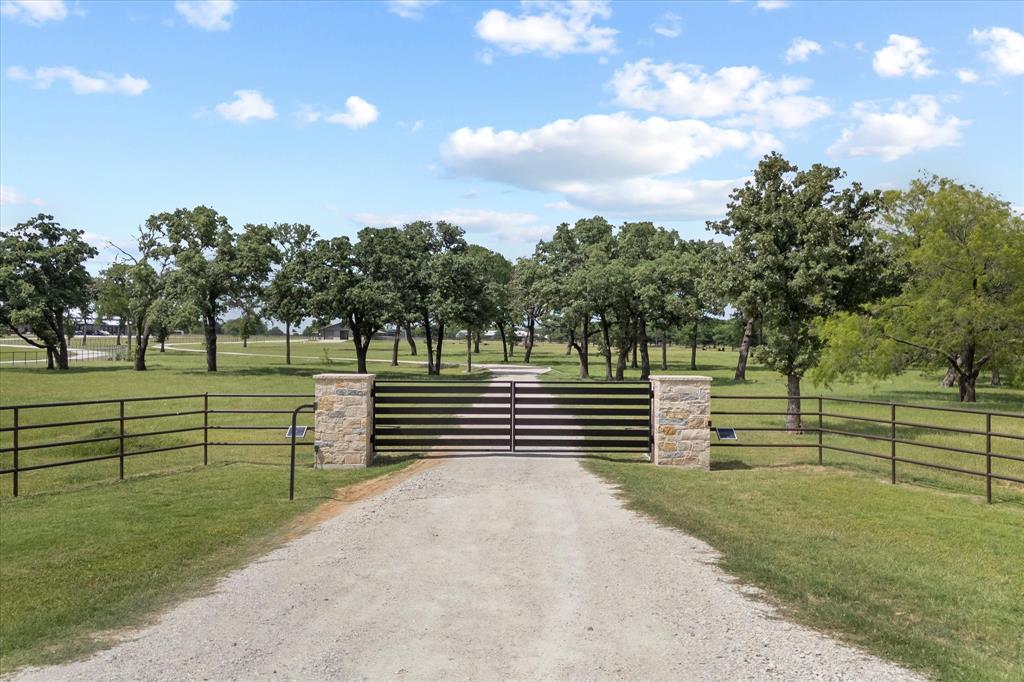 Set on 22 picturesque acres in the heart of Horse Country USA, just north of the DFW Metroplex, this exceptional property offers the perfect blend of functionality, beauty, and opportunity. A stunning, tree-lined drive of mature oaks welcomes you, creating a truly unforgettable first impression as it winds its way to the thoughtfully designed equestrian improvements.
Built in 2024 and designed by an equine expert, the custom 6-stall barn is both practical and impressive. Each stall is equipped with individual fans and lighting, with the ability to divide as needed, and offers direct turnout to lush, well-maintained pastures. The barn also features a feed room, tack room, wash rack, and a versatile workshop ideal for storage or equipment.
Designed with convenience in mind, the property includes RV hookups with electric and a dump station, as well as a secure gated entrance. A tranquil pond provides a natural water source for livestock and adds to the scenic charm.
The beautifully appointed 2-bedroom, 2-bath apartment showcases designer finishes and offers comfortable living just steps from your horses—ideal for owners, guests, or staff.
With two prime build sites, this property offers incredible flexibility—whether you envision a custom home, riding arena, or expanding into a larger equestrian facility. Whether you're seeking a private retreat or a property with room to grow, this one delivers unmatched potential in a highly desirable location.