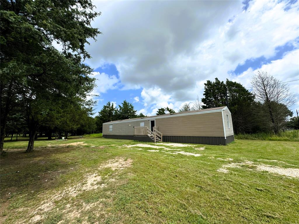 Discover Your Peaceful Retreat in Kerens, TX! Now is the perfect time to invest in your own slice of tranquility. This beautiful 1-acre property offers a wonderful opportunity to enjoy country living at its finest.
The land comes complete with a well-maintained 3-bedroom, 2-bath single-wide mobile home—perfect for a weekend getaway, rental opportunity, or your permanent residence. The lot features just the right balance of mature trees for shade and open space to fully enjoy the outdoors.
A convenient storage unit is also included, giving you extra room for tools, toys, or seasonal gear. Whether you're relaxing outside, listening to the birds, or simply soaking in the fresh air, this property has everything you need to unwind and feel at home.