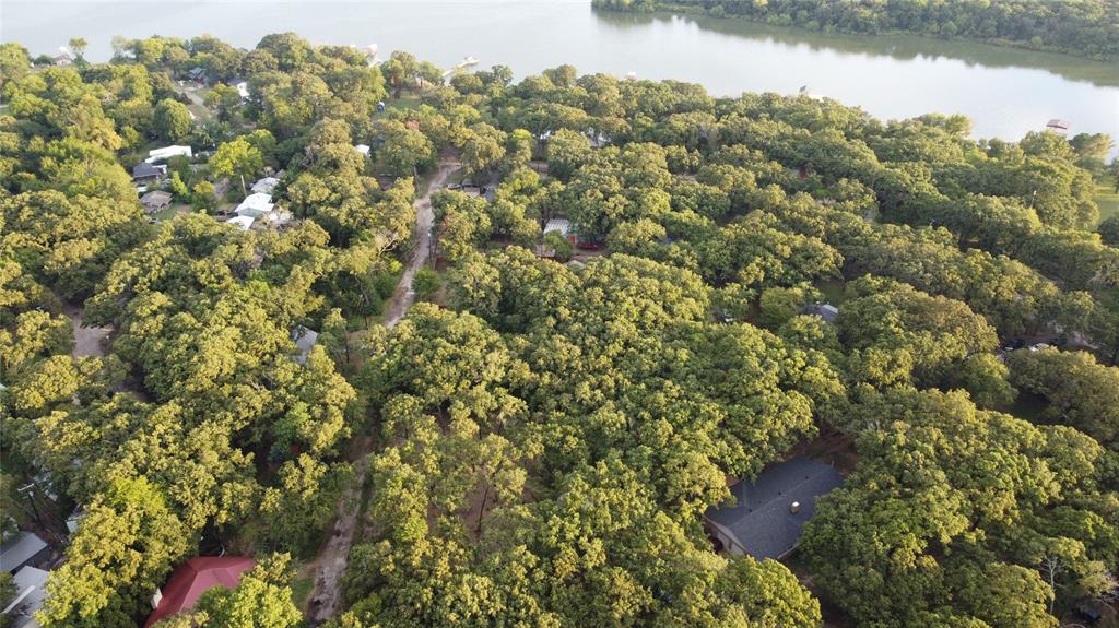 Just off the lake and accessible by a recently repaired road, these contiguous 4 parcels (property IDs: 46116, 46119, 46115, 46120) offer numerous options. Keep them separate or build your dream by the lake on them altogether.  There is already a driveway cut through the center of the property, which connects the roads on either side. The area is heavily wooded. (Please note that the seller will not sell parcels separately.)