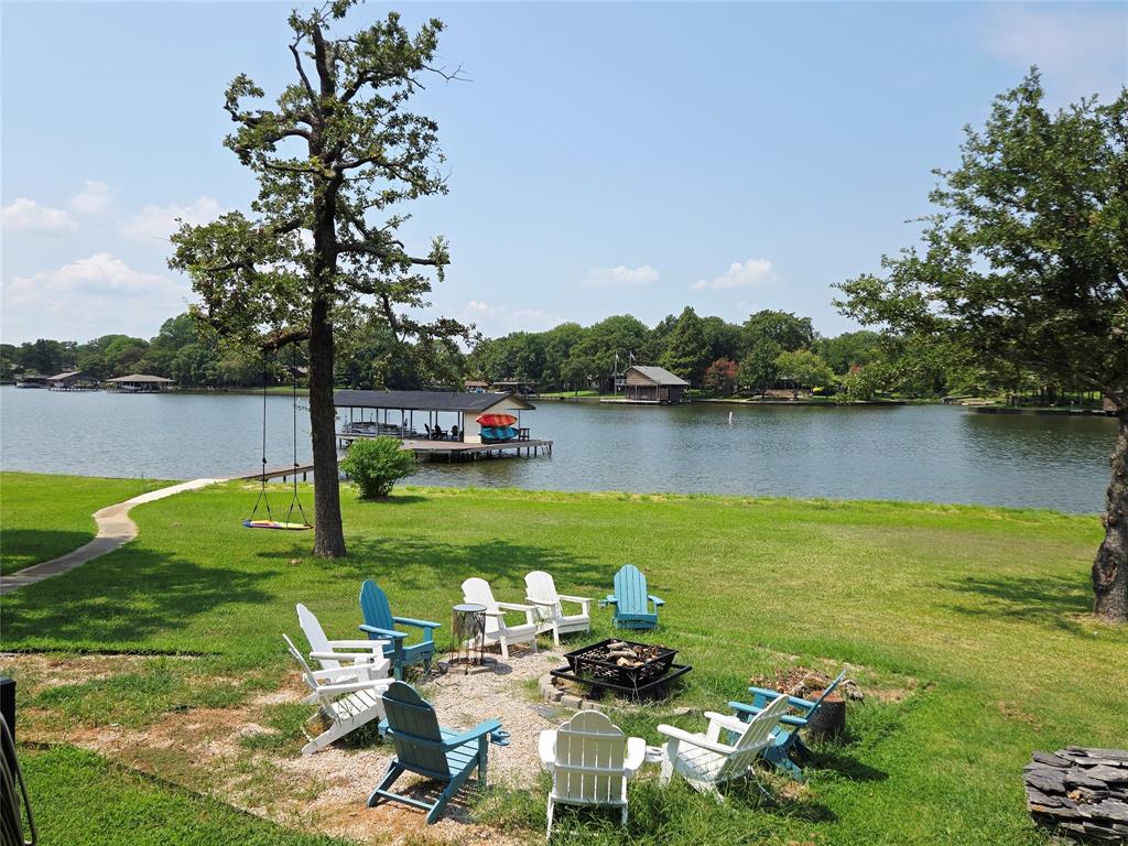 This stunning Cedar Branch Park waterfront home is on a .55-acre lot with over 250 feet of waterfront. It features 4 bedrooms, 3 full baths, and 2 living areas. Recent updates include a NEW seawall, plumbing, and HVAC system. The boat dock has a NEW lift motor and belt, suitable for both ski and pontoon boats. City water and Sewer. A spacious deck is ideal for waterfront relaxation. The second deck can serve as an outdoor workspace, with glass-view garage doors facing the waterfront. Most bedroom furniture is included, and short-term rentals are allowed with POA approval under new ownership. The solar panels are fully paid off and work great year-round, no warranty. EV Charging plug in the garage. There are Showing Blocked Days on the scheduling service due to short-term rentals. 
You must be confirmed before the showings.