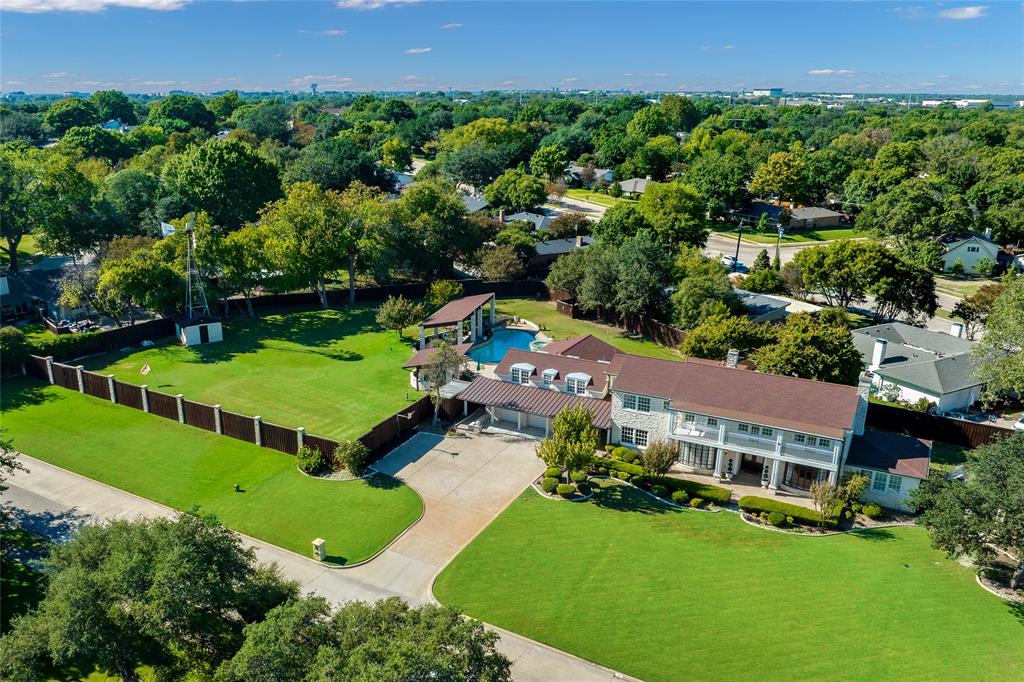 Rural Living in an Urban Environment! Deep in Richardson's iconic Canyon Creek neighborhood you'll find the home that started it all, an Austin stone ranch house on over 1.25 acres. The rich history of this 1939 property abounds; from original hardwood flooring, mouldings, & chandeliers, to the clawfoot tub, and the working well and windmill. Recent renovations seamlessly merge eras past with all of today's modern conveniences. The oversized gourmet kitchen has 2 built-in refrigerator-freezers, JennAir professional 6 burner gas cooktop with double oven, an oversized island, & wet bar with wine fridge. All in a designer palette. Spend a lazy morning relaxing in the master suite, with its own living area, expansive balcony, and spa-like bath, with rain shower & soaking tub. Outdoors is truly an urban oasis with a resort style pool featuring a flagstone beach, 40 ft. subsurface bench, & relaxing spa; large trees, a green house, chip & putt golf course and two extra-large covered patios.