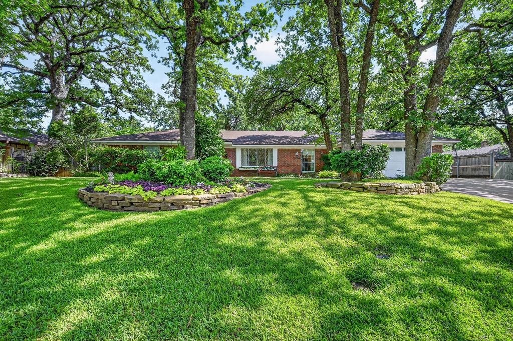 Nestled on a 0.34-acre lot in desirable, established neighborhood, this beautifully updated home with pool offers the perfect balance of privacy, comfort, & convenience. Surrounded by towering mature trees & lush landscaping, the setting feels like a peaceful retreat while remaining just minutes from Interlochen, parks, major highways, shopping, & dining. Incredible backyard oasis with something for everyone to enjoy. A large recently painted deck overlooks the beautifully landscaped yard, creating the perfect space for entertaining or relaxing beneath the shade of mature trees. The upgraded heated saltwater pool and spa, complete with a Polaris system, make this outdoor oasis even more inviting. Large 333 sq ft sunroom with AC & thermo tilt-out windows adds valuable living and entertaining space to enjoy all year long. You'll find LVP flooring throughout a warm, welcoming layout. The family room features a wood-burning fireplace that is also plumbed for gas. Kitchen was updated approximately five years ago and showcases quartz countertops, farmhouse sink, updated cabinets, SS appliances & abundant workspace. The breakfast nook offers additional cabinetry, counters, & storage. The private primary suite is tucked away at the back of the home & features dual sinks, a large walk-in shower, and an updated bath. One of the rooms is a secondary primary suite and is separated from all other rooms, perfect for guests privacy. Every bathroom in the home has been renovated, blending style & functionality throughout. Additional updates include a roof approximately 6 years old, two gas water heaters, & a Carrier Infinity 5-ton HVAC system. The heated two-car garage provides year-round comfort, while additional parking accommodates a boat, RV, trailer, or guests. With its mature trees, extensive updates, exceptional outdoor living spaces, & sought-after location, this home offers a rare opportunity to enjoy a beautiful park-like setting without sacrificing city convenience.