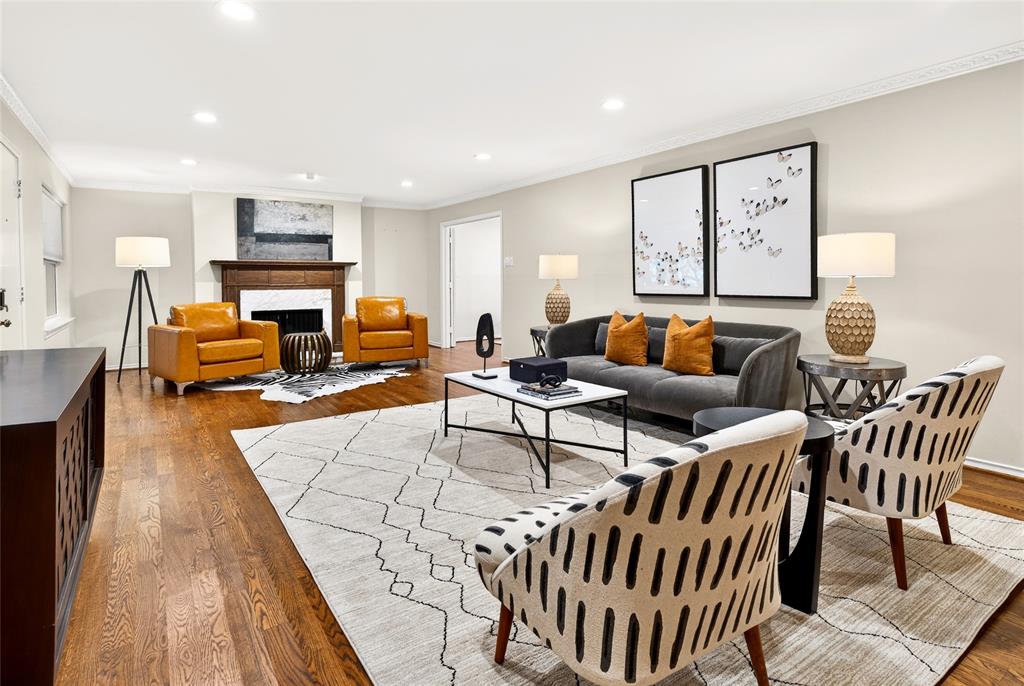 Tucked behind the iconic Pink Wall, this beautifully renovated 2-bedroom, 2-bath residence offers turnkey living in one of Dallas’s most sought-after enclaves. Hardwood floors and a cozy fireplace anchor the main living area, creating a warm, inviting space for both everyday living and entertaining. A private study off the living room adds flexibility and is a rare feature for this unit.

Newly installed windows fill the home with natural light and provide peaceful treetop and pool views. The updated kitchen features custom cabinetry, quartz countertops, a stylish backsplash, recessed lighting, and premium appliances, thoughtfully designed for both form and function.

The spacious primary suite includes an updated bath with a framed glass shower, quartz countertops, and a stacked washer and dryer for added convenience. The secondary bedroom offers its own ensuite bath with upgraded finishes.

The HOA covers all utilities, common area maintenance, and access to the community pool. Two assigned parking spaces convey. This is a true move-in-ready opportunity where the renovations are complete and the lifestyle is effortless.
