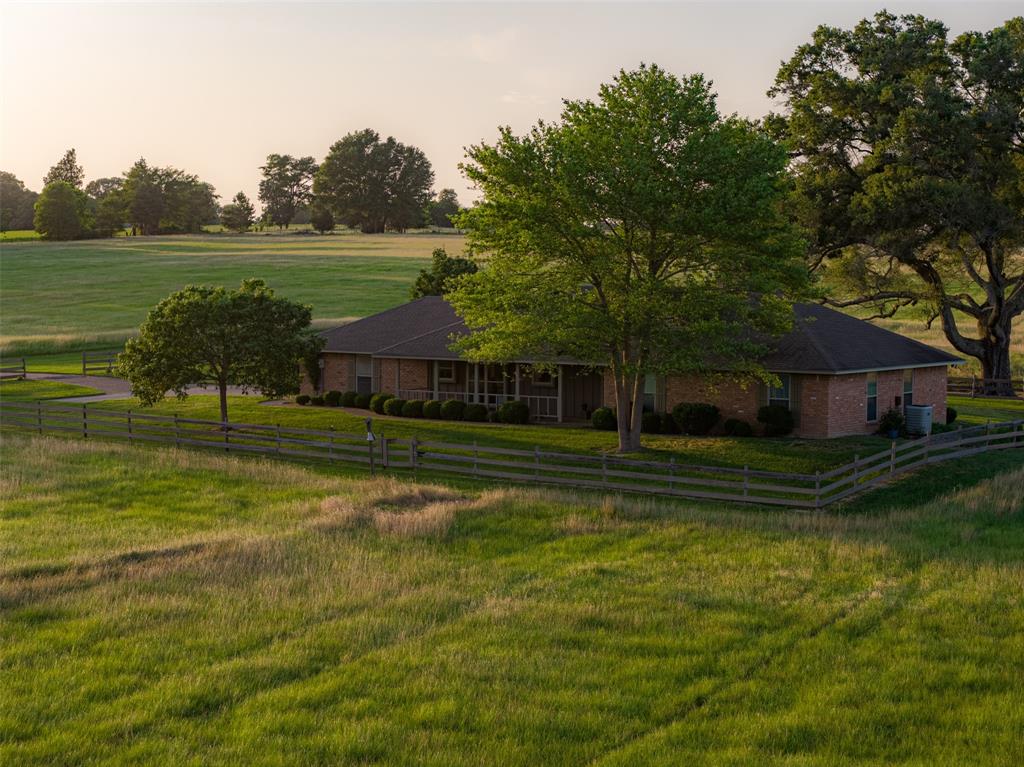 Approximately 140 acres with an ideal blend of open pasture and rolling wooded areas, this property offers the balance, privacy, and natural beauty that buyers love. The mix of habitat is exceptional—expansive openings transition into wooded breaks that feel natural and secluded, giving the land a much larger impression than its surveyed size. Mature oaks are abundant throughout, especially along the winding creek corridor. The creek appears to run year-round and creates a series of water holes that support both livestock and wildlife.
The property is rich in wildlife, including plentiful deer, small game, and a variety of native species that thrive in the diverse landscape. Currently used as a full-time residence and cattle operation, the land is well-set for agricultural and recreational use alike. A thoughtful layout includes two separate entrances off the county road—one for the residence and one for pasture and equipment—ensuring that cattle and large machinery never have to use the main driveway.
The 3-bedroom, 2.5-bath home offers an inviting open living and dining area, with well-appointed finishes in the kitchen and bathrooms. Just outside, a well-maintained in-ground pool with a diving board provides a great space to relax and enjoy the quiet countryside. Whether you're looking for a full-time homestead on acreage or a comfortable weekend getaway with room to roam, this property delivers a rare combination of utility, privacy, and natural charm.

Currently used as both a full-time residence and cattle operation
Two separate entrances—one for the home and one for pasture, equipment
Approx. 1,939 square foot, 3 BR, 2.5 BA home with an open living, dining layout and quality finishes
Well-kept in-ground pool with diving board
Ideal for a permanent residence on acreage or a peaceful weekend retreat
Boundaries in yellow to be verified by survey