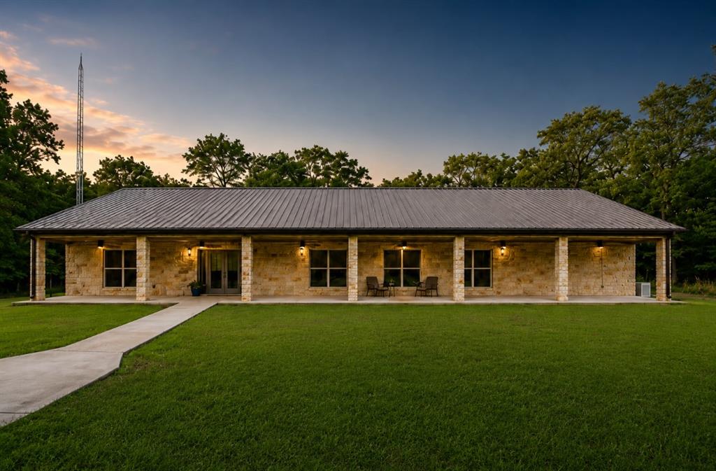 Welcome to your private East Texas retreat where peaceful country living meets modern comfort, security, and quality craftsmanship. Nestled on 14 beautiful wooded acres, this custom-built property offers unmatched privacy, breathtaking scenery, and a quiet lifestyle that is hard to find. From the moment you enter through the gorgeous gated entrance and travel down the tree-lined driveway, you will immediately feel the serenity and charm this property has to offer.
The home features 3 spacious bedrooms, 2 bathrooms, and a media room designed for relaxing evenings and entertaining guests. Built with durability and efficiency in mind, this home was constructed entirely with metal structural framing, including metal 2x4 construction throughout, creating a solid and long-lasting foundation rarely found in residential homes.
Inside, you will find a living spaces with large windows that bring in natural light and showcase the surrounding acreage and peaceful views. Whether hosting gatherings or simply relaxing after a long day, this home provides the perfect atmosphere.
Safety and preparedness were also priorities in this build. The property includes a full security system, an amazing safe room, a 2-year-old Generac whole-home generator, and an internet tower providing dependable connectivity for working remotely or streaming.
Step outside and experience everything this incredible acreage has to offer. The property includes two stocked ponds perfect for fishing and enjoying nature right in your own backyard. Trees surround the property, creating a peaceful setting filled with wildlife, shade, and privacy.
In addition to the home, the property also features a spacious two-bay shop offering excellent storage, workspace, or room for hobbies and equipment. This rare property combines luxury, security, quality construction, and natural beauty all in one incredible package. Home is being sold fully furnished with a few exclusions of personal property!