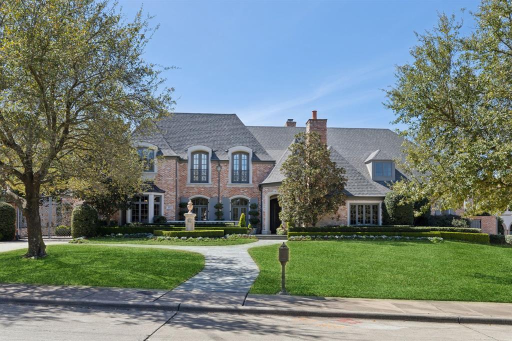 Nestled inside a private North Dallas wooded estate neighborhood on a cul-de-sac, this breathtaking French Provincial Estate is an architectural masterpiece. Crafted by Hawkins-Welwood Homes, it is a timeless haven that has been more than meticulously maintained and made for ultimate entertaining. From the grand entrance and porte-cochére lies a world of absolutely EVERYTHING. Custom finishes throughout the entire home. Full house generator. The prime location boasts comfort, sophistication, and ease of entertainment. Main house offers 10,369 sq ft including 6 bedrooms, 6 full baths, 3 half baths, 2 full size laundry rooms, one upstairs one down, plus a private guest haven-584 sq ft- above the garage not included in main house sq footage, 4 garage bays total. The chef's kitchen reaches out to a large breakfast room with fireplace, and family living area. Double formal living room is flanked by a huge dining room adjacent to a Butler's pantry and mudroom. The North wing encompasses the Primary retreat with triple closets including a large cedar closet, immense tub, access to completely finished basement-406 sq ft-, and a private study overlooking the magnificent one-of-a-kind grounds. You are lifted to the second story by grand dual staircases to an entire environment - lounge, media room with makeup or massage room, playroom, 4 unbelievable ensuite bedrooms, one a secondary Primary suite, all generously aligned with the ultimate in storage and tree top views of the verdant forest outside with luxury tree lighting by Lentz Landscape Lighting. An outdoor paradise built by world renowned Lamberts Landscape Design Paul Fields, with over 6000 sq ft of French antique limestone, including resort-style deep pool, a sprawling Loggia measuring 50x17, covered bar & outdoor kitchen, fountains, and a walking track. Unmatched for serenity & security, you will believe you are at the Waldorf Astoria in Versailles. This home is unprecedented for luxury and location.