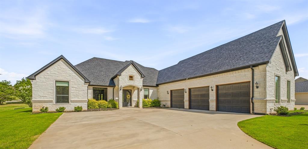 Luxury living at its finest in the gated community of Pecan Plantation with unlimited golf. This stunning custom home sits on a half acre lot and offers a refined blend of elegance, comfort, & thoughtful design. With 4 spacious bedrooms, 4 full bathrooms, a media room, private office, plus an open floor plan, every detail has been carefully considered. The light-filled living area features large windows with electric shades and a gas fireplace, creates a warm, inviting atmosphere. The chef’s kitchen is designed for both beauty & function, showcasing a commercial-grade gas range, oversized breakfast bar, abundant cabinetry, & an oversized walk-in butler's pantry with sink, ice maker, & tons of cabinets, ideal for entertaining & everyday living.

The primary suite is an exceptional retreat, complete with its own gas fireplace, expansive windows with electric shades, spa-inspired ensuite featuring separate vanities, a soaking tub, walk-in shower, and an impressive custom closet with a dedicated dressing and makeup area plus a private closet for weapon storage. The utility room connects directly to the primary closet and includes built-in cabinetry, tons of counter space, and room for a secondary refrigerator or freezer. 

Upstairs offers a media room with a full bathroom, perfect for guests or movie nights. A dedicated office with French doors & dual built-in desks provides an ideal work-from-home space. Outdoor living is just as impressive with a fully fenced backyard, covered entertaining area with built-in Green Egg, gas grill, refrigerator, generous seating, and a wood-burning fireplace with room for a mounted TV.

Additional features include an oversized, deep three-car garage and custom finishes throughout, and whole-home generator. Pecan Plantation residents enjoy gated security, golf, marina access, clubhouse amenities, lake privileges, and a luxury lifestyle unmatched in Granbury including its own grocery store, pharmacy, bank, hardware store & more.