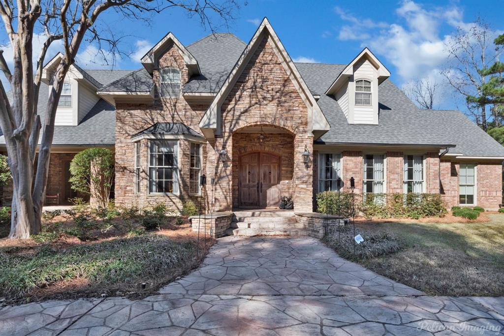 Incredibly located on 12.26 acres inside quiet, gated Forest Creek.  This custom built home features
a circular driveway leading to a double door entry that leads to a two story foyer with beautiful
Caribbean Cove wood flooring.  Lovely floorplan with private study (piano room) with built ins, 
formal dining area, living area
with soaring ceilings and fireplace, arched windows overlooking grounds and pool area. Fantastic
kitchen with brick flooring, butlers pantry, walk in pantry, large bar area for seating and all open
to cozy hearth room with fireplace.  Wet bar with granite counters.  Large playroom downstairs,
media room with bar area and screened porch.  Great primary suite with gas log fireplace, wall
of windows overlooking grounds and large primary bath with double vanities, jacuzzi tub, stall
shower.   Incredible outdoor area great for entertaining!!! Mother in law suite with kitchen, full
bath, living area.  4 car garage and additional 3 car garage.  So many amenities!!