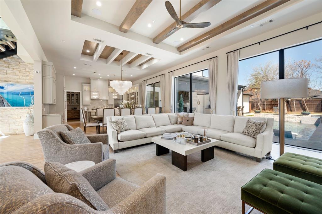 Welcome to this stunning V. Patrick Gray Custom Home, nestled within the prestigious Southlake Carroll ISD. Every detail of this masterpiece showcases impeccable craftsmanship, blending brick, stone, and stucco with a striking modern iron door. Step inside and be welcomed into the heart of the home—a breathtaking great room designed for both grand entertaining and intimate family gatherings. The chef’s kitchen is a dream, fully equipped with top-of-the-line Thermador appliances, an oversized cooktop, refrigerator, and double ovens, all overlooking a spacious dining area and living room. A sleek modern gas fireplace and 10-foot sliding glass doors open to an expansive patio, which can be fully enclosed with drop shades for year-round comfort. Additional highlights include a well-appointed back kitchen, a temperature-controlled wine closet, a generous utility room, a first-floor media room, and a second bedroom with an ensuite bath on the main level. The private primary suite is a true retreat, featuring a spa-like bath, a luxurious walk in closet with high-end finishes, and a stackable washer and dryer. A stunning floating staircase leads upstairs to two additional bedrooms, each thoughtfully designed. Throughout the home, magnificent chandeliers and designer lighting add a touch of elegance. There is a third bay garage that is currently a spacious office with an external entrance and dedicated parking completes this exceptional property, along with a second attached two-car garage for ultimate convenience.