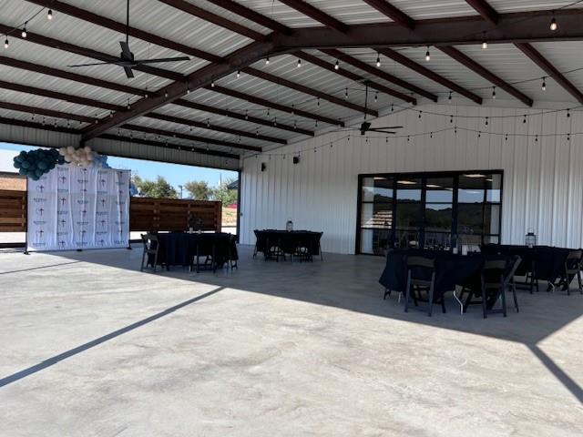 Discover this beautifully designed 6,000 sq. ft. air-conditioned event venue situated on 2 acres just outside the city limits of Graham, TX. Built in 2013, this versatile property offers an ideal setting for weddings, corporate events, private parties, or a wide variety of commercial uses. The main building features a spacious open floor plan with high ceilings and ample natural light, creating an inviting atmosphere for gatherings large or small. A commercial kitchen is in place for catering. The covered 2,000 sq. ft. patio provides additional space for outdoor entertaining, dining, or live music — all while showcasing stunning hill country views that make every event memorable. Music can be piped throughout the space. With approximately 85 designated parking spaces, guests will appreciate the easy access and convenience. Located outside city limits, the property allows for more flexible business operations while remaining close to town amenities and lodging. Whether you’re an investor seeking a turnkey event center or an entrepreneur looking to bring a new vision to life, this property offers endless potential in a scenic and sought-after North Texas location.