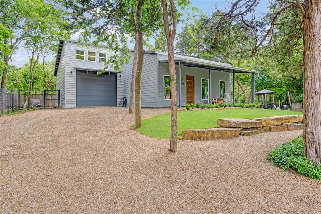 Live the lake life without compromise. Tucked inside Simmons Shores, one of only a few neighborhoods on the Texas side of Lake Texoma with a private community boat launch, this custom-built 2 bed 2 bath delivers the rare combination of thoughtful design, serious storage, and an outdoor space built for living.

The home's structural design elements set it apart from standard builds, and fresh interior and exterior paint give it a move-in ready feel throughout. The pantry features a steel safe room for peace of mind.

The showstopper: an attached 1,200 sq. ft. air-conditioned garage, with soaring ceilings, epoxy floors, and room to store a boat or water toys without paying for off-site storage. Buyers with an eye toward flexibility will note the space could also accommodate an additional bedroom.

Step outside to a fully equipped outdoor living setup: a firepit area, a dedicated gas grilling station with granite countertops and a sink, an outdoor dining table with chairs and umbrella, a hammock, and mature shade trees. The kayak is negotiable, so you could literally be on the water your first weekend.

The home conveys with washer, dryer, refrigerator, gas grill, outdoor dining set, and hammock...making this one of the most turnkey lake properties you will find at this price point.

The Simmons Shores community adds even more: a community pool, a gazebo, and a playground - everything you need for a full lake lifestyle without leaving the neighborhood.

Located minutes from Highport Marina for days on the water, and minutes from Tanglewood Resort for a round of golf when you feel like switching it up.

Lake Texoma is calling. This one answers back.