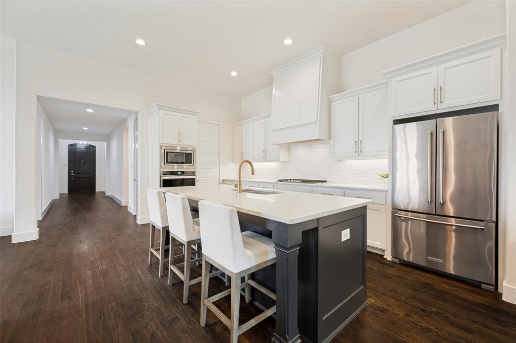 Custom Shaddock home in quiet cul-de-sac location in Stonebridge Ranch.  Beautiful dark real hardwood flooring meets you at the front door, continues down wide hallway and into large and open great room area.  Kitchen is well appointed:  walk-in pantry, oversized gas cooktop with vent-a-hood.  Giant island overlooks living and dining area.  Living room boats fireplace and double glass doors out to a covered patio.  Primary suite is separate from the other bedrooms, boasts large walk-in closet.  Luxury finish out!  Enjoy all the amenities Stonebridge Ranch has to offer:  miles of hike and bike trails, tennis courts, pickleball courts, swimming pool, numerous playgrounds, stocked ponds.
