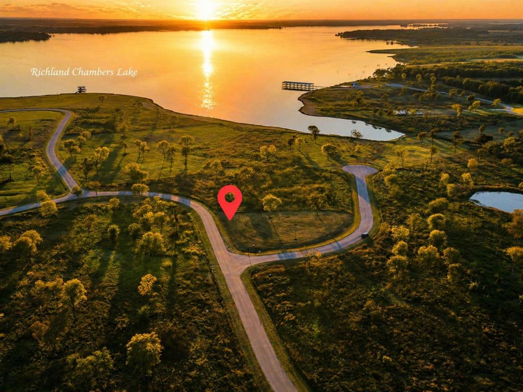 BOAT SLIP IS INCLUDED WITH THIS LOT!!! Imagine ending every day with a sunset over the water. This beautiful lot offers the best of lake living—peaceful views, golden skies, and a slower pace of life—all without the high waterfront price tag. Perfectly positioned to capture breathtaking views of Richland Chambers Lake, this property lets you experience the magic of lake life from your own front porch. Bring your vision and create your own retreat in a community where weekends feel like vacations. Whether you’re looking for a quiet escape or a place to build your forever home, this property offers access to all the community amenities.Watch the sun sink into the horizon, listen to the gentle waves in the distance, and feel the stress of the day melt away. Life at the lake isn’t just about the water—it’s about the feeling. And here at Richland Chambers Lake, you can have it all.