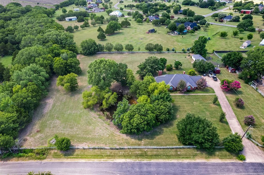 What if your next home wasn't perfect yet—but the land, the setting, and the bones were already there? A rare opportunity to own more than 3 acres of Texas countryside with a pond, a creek, established surroundings, and room to create something truly your own. Located outside the city limits with no HOA and served by Palmer ISD, this is the kind of property buyers search for when they are ready for more space, more privacy, and fewer restrictions. The house is ready for its next chapter. With 4 bedrooms and 3.5 baths, the size and layout provide a strong foundation for a full transformation. Yes, it needs work—but some of the beautiful updates have already begun, including a renovated kitchen that offers a glimpse of just how special this home could be. Bring your ideas, your vision, and breathe new life into a property with great bones and so much potential.
Outside is where the dream really starts to take shape. Imagine time at the pond, afternoons exploring along the creek, a garden that finally has room to grow, chickens in the yard, or simply enjoying the quiet that comes with having more than 3 acres to call your own. The detached workshop adds valuable space for tools, equipment, projects, hobbies, or the person who can never have enough room to tinker.
This isn't a polished, cookie-cutter home waiting for someone else's furniture. It's an acreage property in Ellis County waiting for the right buyer to write its comeback story. If you've been searching for a fixer-upper on acreage near Palmer, Texas, a 4-bedroom country home with a pond and creek, property outside the city limits with no HOA, or a Texas home with a detached workshop and room to make your own—511 Farrar Road may be the opportunity you've been waiting to find. Bring this house back to life. The country setting is already here.