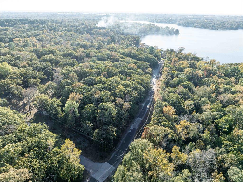 Two nicely wooded lots in the gated community of Callender Lake which features a 365 acre spring fed Lake.  These great lots total about 0.64 acres and would be a great place for your weekend get away or full time residence in East Texas.  These lots are only two blocks from the lake which can be seen from the one side of your property and possibly from a two story home.  Homes in the community must be site built and a minimum of 960 sq. feet of living space or more.  Water meter is installed at the street on this property.  Electricity is located at the street and a septic system will be required when you build your home.  RV's can be stayed in for two weeks each month but can not be lived in full time in this community.   No mobile or modular homes allowed.  The community has a boat ramp, fishing pier, children's park, lake swim area, great fishing, boating, and swimming.  Located just 30 minutes to Tyler and about 90 minutes from Dallas with easy access to other small towns and all the things you will need to enjoy your time at the lake.  This is one you are going to want to see.   Come today and start living the LAKE LIFE!!!