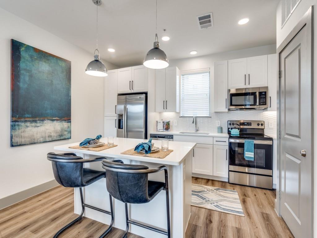 This brand new, thoughtfully designed townhome is ready to go! The first level features a 2 car tandem style garage with storage space. Up the first set of stairs you'll find the kitchen, living area and half bath. The kitchen has stainless steel appliances, sleek white countertops, and an island perfect for meal prep or dining. Natural light pours through the large windows that open up to a balcony. Ascending to the third floor, you'll find a landing space perfect for a home office and the laundry closet. The oversized bedroom features a second balcony, a sitting area, an ensuite bath and walk in closet. This townhome offers easy access to shopping, dining, & entertainment. Amenities include an gorgeous infinity edge pool, gym with the latest equipment, grilling stations, fire pit, co-working space, lake with jogging path and two dog parks.