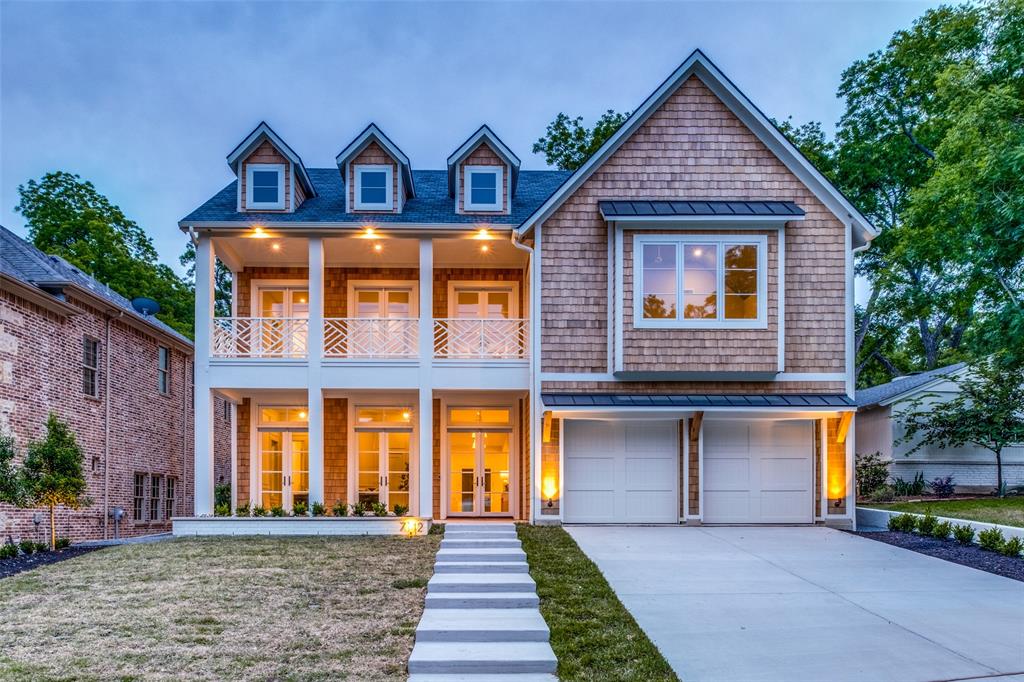 Developed by Dallas luxury experts Santa Barbara Homes, the two-story, Cape Cod-inspired 5,482 square-foot house is a magnificent respite near the shores of White Rock Lake. In a prestigious neighborhood known for its walkable demeanor, Wildgrove Ave is attractive in that the lot sits on a winding street, peppered with mature trees, varying elevations, and a mixture of architectural styles. This house is filled with natural light, wooden floors, and superb touches. There are five spacious bedrooms and baths, a home office, a game room, and a flex room. A chef’s kitchen is perfect for family and friends to gather, cook, nosh, and share conversation around a custom island near a walk-in pantry, reeded wood detail on cabinets, and a designer vent hood. The spectacular family room features a wood-burning fireplace, and the bar is the picture of sophistication, accented with alabaster sconces and custom carvings.