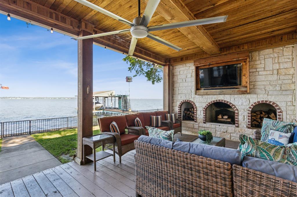 Great location with deep water!  This stunning lakeside home offers picturesque sunsets over open water, best enjoyed from the recently updated dock or the spacious covered patio. The dock features an upper deck with storage for a boat and two jet skis, along with easy water access via stairs leading directly from the deck, making it perfect for swimming, boating, and other water activities. Inside, large windows provide breathtaking views and fill the home with natural light. Recent updates include new flooring and a primary suite with direct access to the roof deck, offering a private spot to relax. Three additional bedrooms and bathrooms for guest.  Possibility for a 5th bedroom currently setup as a second living room with double murphy beds. 
Currently setup to sleep 14, this property is ideal as a permanent residence, a weekend getaway, or a smart investment. The gated yard provides privacy, while two covered parking spots add convenience. Located with easy access to dining along the lake, this home combines comfort, style, and the best of waterfront living. HOA provides community boat ramp and park for private use.