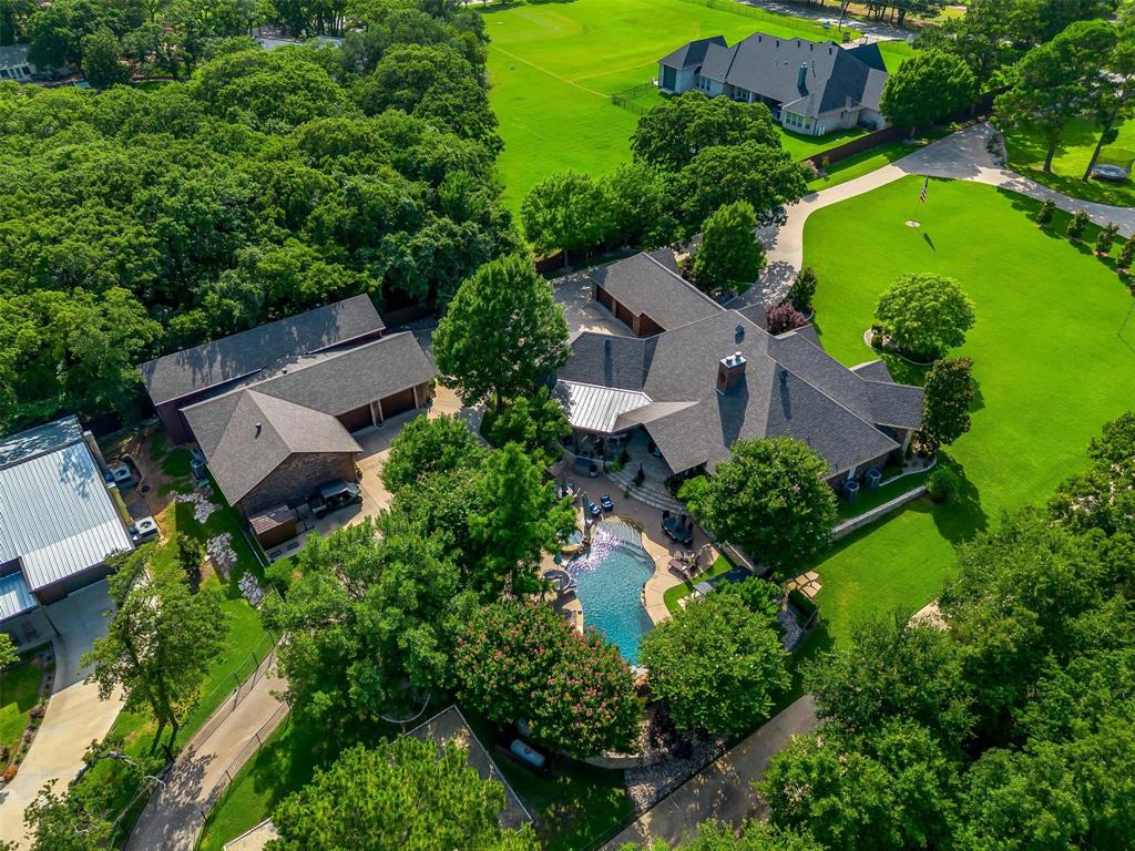 Extraordinary Multigenerational Estate or Private Event Venue on 4.49 Acres – Two Luxury Residences, Resort-Style Amenities, and Premier Accessory Buildings.  Discover a one-of-a-kind manor featuring two luxury homes, exceptional outdoor living spaces, and first-class accessory buildings – located on a private get away with magnificent landscaping with a dual gated entry and paved access throughout.  Amenities include: 8’ tall privacy fencing on side, sand beach volleyball court, and shooting range with backstop and interior storage container. Luxury Accessory Building 1: RV garage with roll-up door, three-bay car garage, gym, sauna, safe room, conditioned office with bathroom, and climate-controlled space throughout.  Luxury Accessory Building 2: Classic car showroom with commercial-grade HVAC, large roll-up door, mobile privacy walls, covered porch, three glass roll-up bays, and covered back awning with batting cage. This is a rare opportunity to own a fully developed multigenerational compound with resort-style amenities, endless entertainment spaces, and extraordinary storage for cars, RVs, and toys – all within a private, gated setting.  The property offers expansive indoor and outdoor spaces that can accommodate large groups while still maintaining an intimate and inviting atmosphere that could host everything from weddings and receptions to corporate gatherings, parties, and community events.  With plenty of room for customization and strong income potential, this property presents an outstanding opportunity for investors or operators looking to step into the thriving events industry.  Both 3208 & 3212 County Road 531 must be sold together.