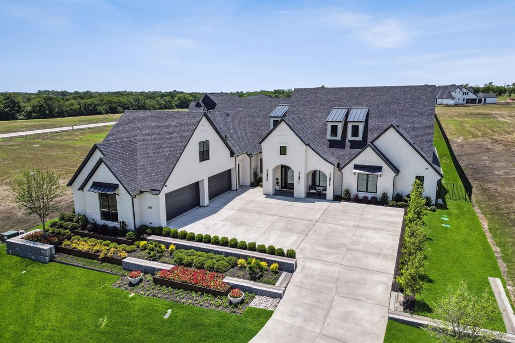 This stunning completed home in Redbud Gardens is the perfect blend of luxury, customization, and craftsmanship—another exceptional creation by Homes by J. Anthony. Set on a spacious lot, this home offers privacy and tranquility within a beautifully designed, upscale community. The unique custom pool creates a showstopping centerpiece, ideal for entertaining and unwinding in style. Inside, the home impresses with thoughtful design and elegant details. A chef’s dream kitchen is paired with a dedicated prep kitchen, perfect for entertaining or everyday functionality. The open layout features expansive slider doors from the family room to the backyard, seamlessly connecting indoor and outdoor living. The primary suite is a true retreat, featuring spa-inspired finishes in the bathroom and a thoughtfully designed closet with direct access to the laundry room. Enjoy year-round outdoor living on the covered patio with a cozy fireplace, overlooking the sparkling pool and fenced backyard. This home embodies comfort, luxury, and elevated living — all within one of Celina’s most desirable new neighborhoods. One of the fastest growing cities, Celina offers a promising investment opportunity by becoming part of a dynamic and expanding community that provides a rural feel with nearby conveniences, top-rated schools, shopping, dining options, & entertainment venues! Accolades from the Texas Association of Builders Star Awards, Dallas Builders Association ARC Awards, and McSam Awards further underscore Homes by J Anthony’s reputation for excellence.