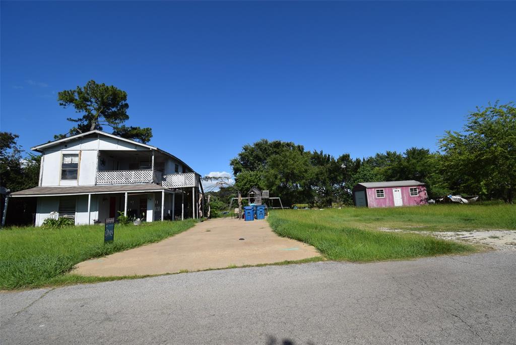 Very unique home located in Harbor Point Subdivision. This two story home features a full house on the bottom floor and a full house on the top floor. Bottom floor features three bedrooms and 1 bathroom. The top floor features two bedrooms and one bathroom. Original home was built on stilts and the bottom half was built at a later date. The home is in need of repair and a complete remodel. Priced accordingly for the repairs needed. Property features three lots. Home sits on one lot. A storage building sits on another lot. The second and third lot could easily have new homes built. Property totals 0.4 of an acre! Property is priced $150,000 under property tax value. Come put your creative cap on and turn this home into your dream home. This would be a great property for families to live together and still have their own space.