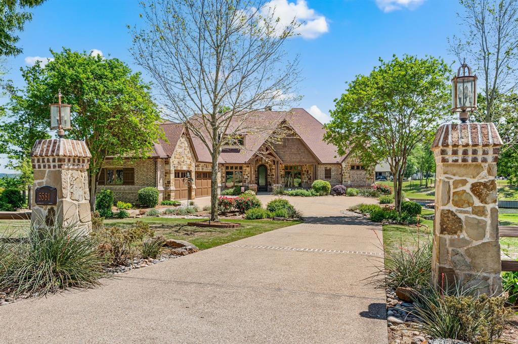 This Brown's Landing estate has become Lake Palestine's best buy, just 90mins from Dallas & 35mins from Tyler! The stunning estate spans 2.1 acres, featuring 442 ft of shoreline providing immediate access to open waters while offering the serenity of a cove. Say goodbye to extensive maintenance associated w open-water homes; this property perfectly blends the joys of lakeside living w comfort of a protective cove. Step inside, you are greeted by bright & airy living area that boasts soaring vaulted ceilings & elegant design elements. Cozy fireplace invites you to unwind during chilly evenings, creating warm & inviting atmosphere. Open floor plan promotes seamless flow between living space, formal dining rm, & gourmet kitchen, which is highlighted by oversized island ideal for entertaining guests. Picture sipping your morning coffee on your covered patio, warmed by wood-burning fireplace, while soaking up breathtaking sunrises. Versatile bonus rm with captivating views is perfect for family meals or lazy afternoons. Primary suite is spacious sanctuary boasting impressive bathrm w coffee bar & private access to backyard. Thoughtfully designed lower level is entertainer’s dream, featuring extra living area w fireplace, game rm w pool table, bar for mixing up your favorite drinks, & media rm w updated Full Swing golf simulator for year-round fun! The home comfortably sleeps 10+ guests ensuring ample space for family gatherings, weekend getaways, or entertaining friends. 3-stall boathouse w stunning Garapa Brazilian hardwood deck & freshwater access is ready for fishing, boating, & skiing. The extraordinary home blends luxury & comfort featuring newly upgraded Crestron home automation system, Hickory wood flooring, Generac Whole House 36KW backup generator, & 2 buried propane tanks (1000 & 500). Visualize your new lifestyle & endless possibilities that await w virtually staged images, showcasing potential of this exquisite property. This property is truly one-of-a-kind!