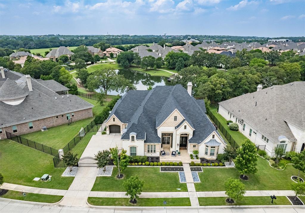 Luxury awaits in this single-story gem in Southlake's coveted Winding Creek. Situated on a premium view lot, offering breathtaking vistas of lush greenbelts, a serene pond, and meandering walking paths it offers acreage-like tranquility without the upkeep. Architecturally stunning with arches and wood beams, high-end designer finishes adorn every corner. The dream kitchen boasts Sub-Zero and Wolf appliances, while the oversized island connects seamlessly to the great room, dining, and game room with a wet bar and wine room. Adjacent to the game room, a private and fully equipped media room awaits.  Retractable patio doors and remote patio screens extend the entertainment area to the outdoor kitchen and resort-style pool including an oversized fire pit to unwind by. The primary suite is a retreat with a lavish bathroom and expansive closet. 4-car garage, gated driveway. Upscale shopping, dining, and exemplary schools nearby. Don't miss this unrivaled opportunity!