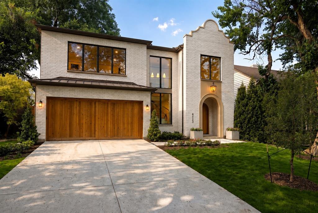 A sophisticated Modern Spanish Revival with warm organic influences. Thoughtfully designed by Ryan Jacobson Design brings to market this new construction in the heart of prestigious Lakewood,  with over 5,100 square feet of refined luxury living. This stunning 5-bedroom custom home seamlessly blends timeless architecture with today's most sought-after finishes and floor plan.
A dramatic arched entry welcomes you into light-filled interiors featuring soaring ceilings, wide-plank hardwood flooring, designer millwork, statement staircase, and an effortless open-concept layout. The spacious living room is anchored by a beautiful fireplace with custom built-ins and opens to the covered patio, creating the perfect indoor-outdoor entertaining space.
The chef's kitchen is the centerpiece of the home, showcasing an oversized waterfall island, premium Wolf® professional appliances, integrated Sub-Zero® refrigeration, custom cabinetry, designer lighting, and an elegant Champagne Bronze hardware package.
The first-floor primary retreat offers exceptional privacy and features a spa-inspired bath with a freestanding soaking tub, oversized glass-enclosed shower, dual vanities, designer gold-toned mirrors, and an expansive walk-in closet.
A private study and first-floor guest suite provide ideal flexibility for work and visitors. Upstairs offers three additional bedrooms, spacious game room, dedicated media room, and abundant storage.
Built with quality in mind, the home features 2x6 exterior wall construction, foam insulation, enhanced attic insulation, premium windows, and carefully curated designer finishes throughout.
Located on one of Lakewood's most desirable streets, just minutes from White Rock Lake, Lakewood Country Club, Lakewood Shopping Center, award-winning schools, dining, and shopping, this home offers the rare opportunity to enjoy modern luxury in one of Dallas' most established neighborhoods.